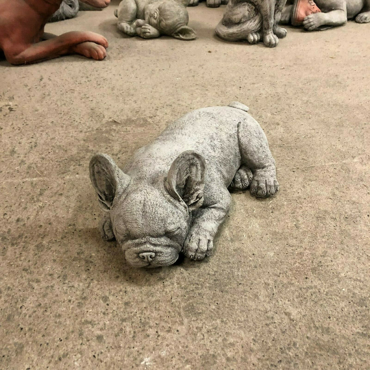 Top-down view of Stone Sleeping French Bulldog Garden Ornament, compact and durable for home garden or porch decoration.