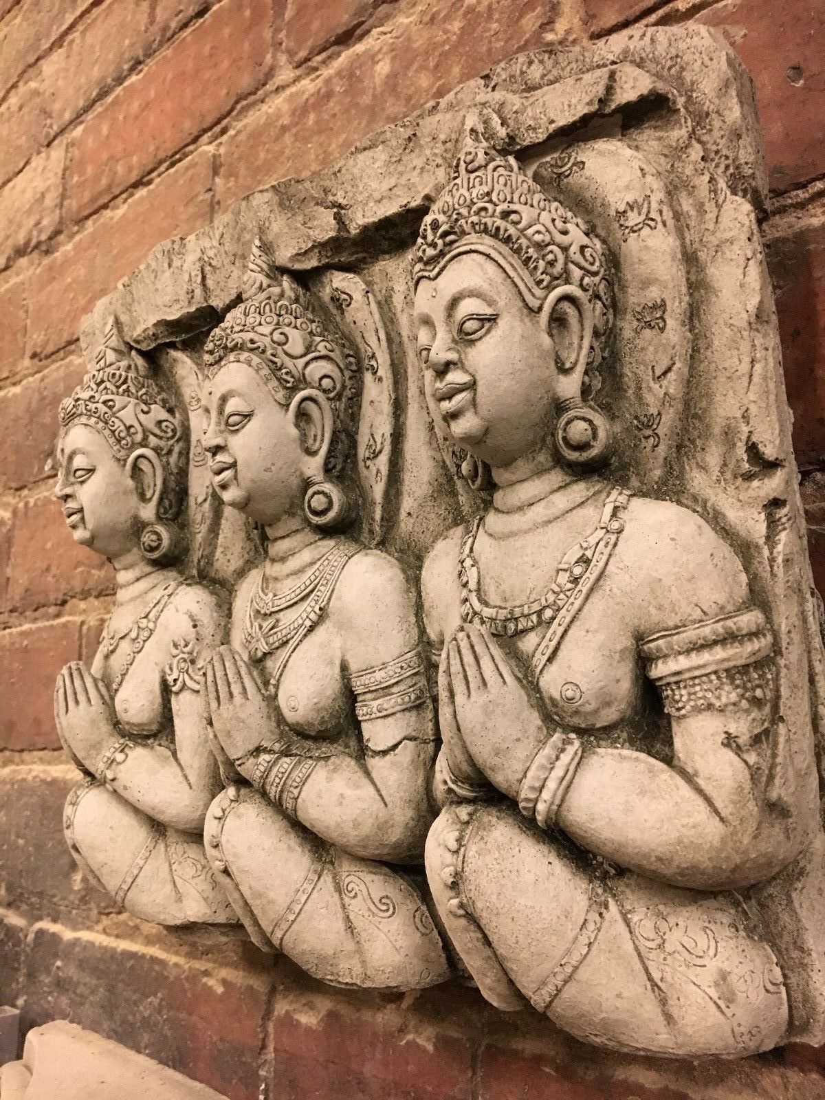 Side view of Stone Buddha Wall Plaque showing detailed craftsmanship. Perfect for outdoor garden decor with steel hook for easy hanging.