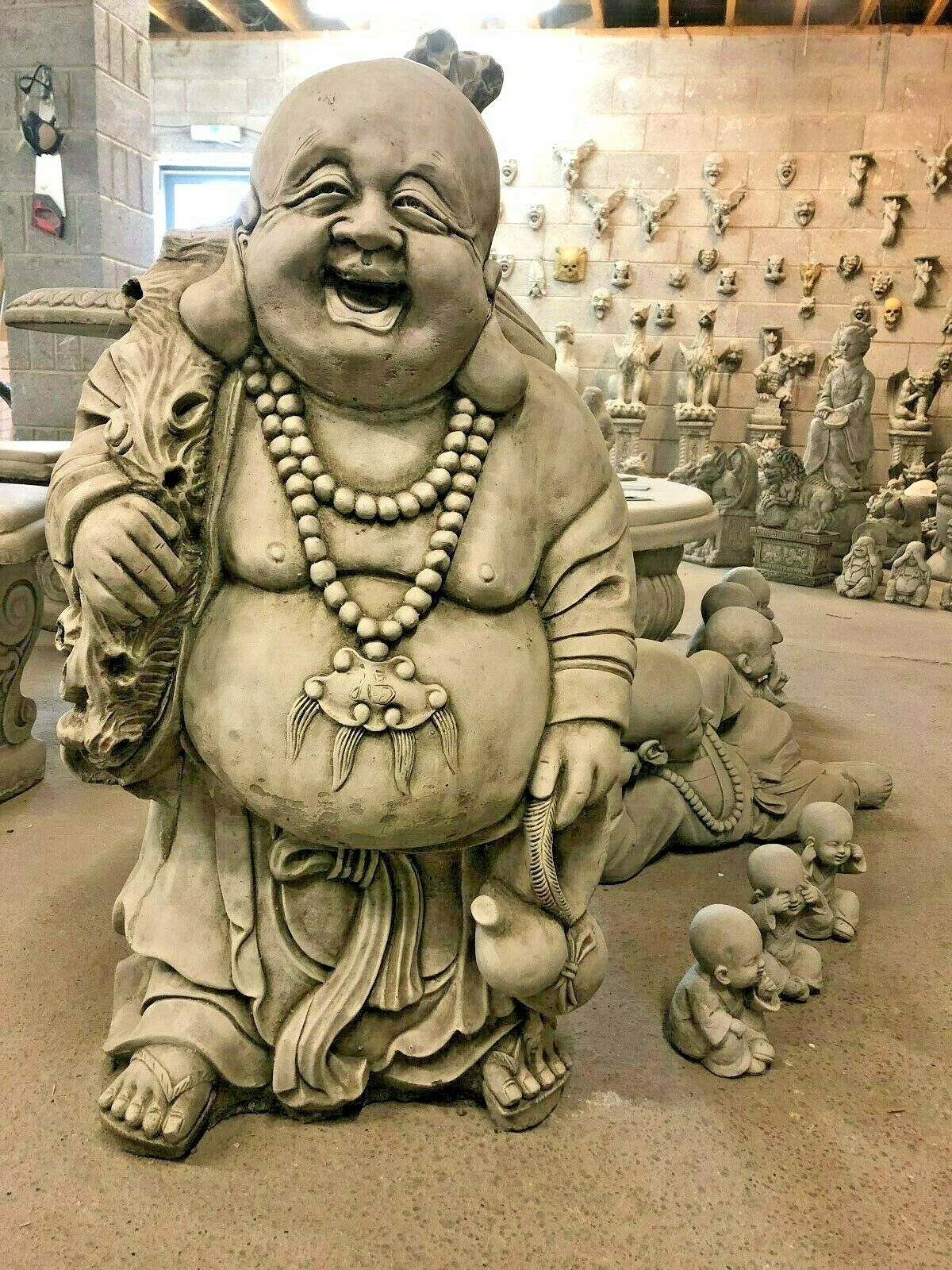 Large Stone Laughing Buddha Statue with joyful expression and prayer beads, symbolizing fortune and serenity for home or patio decor.