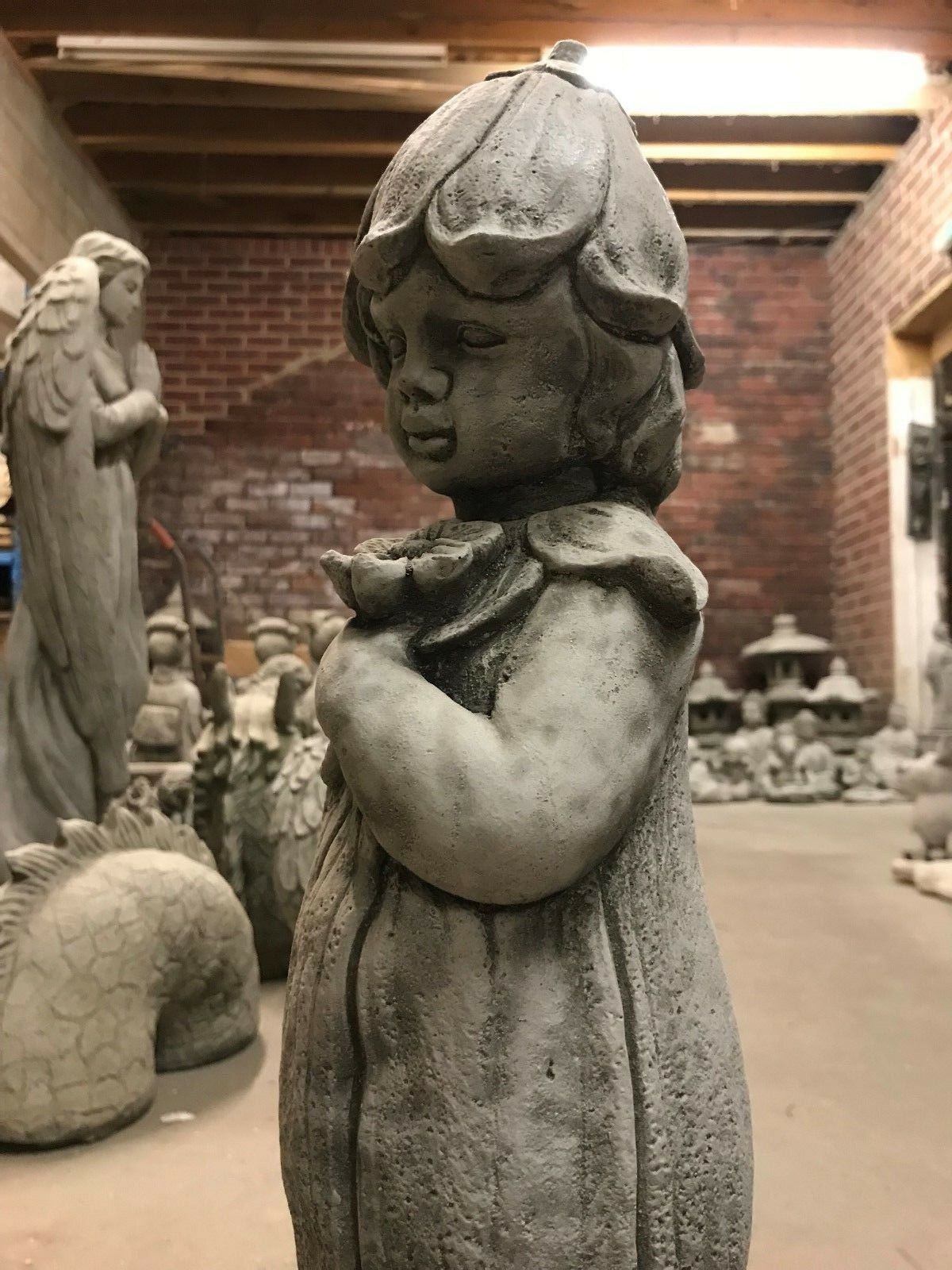 Profile view of the Stone Bluebell Girl Statue with detailed facial features and floral hat, ideal for home and garden ornamentation.