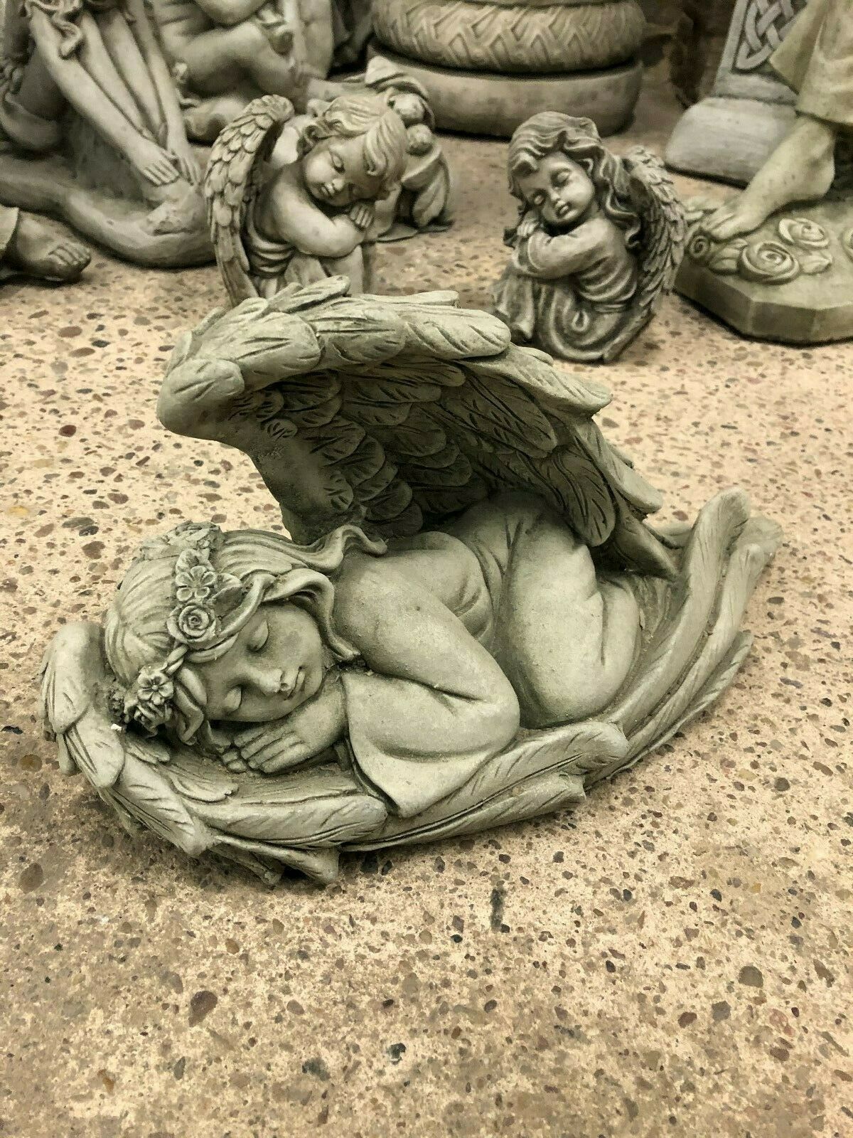 Stone Angel Tiara Ornament for garden decor featuring a sleeping angel with floral tiara and detailed wings. Antique grey finish for outdoor use.