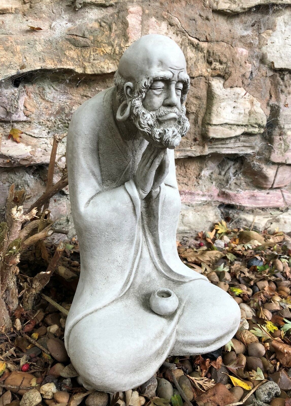 Three-quarter angle of the Stunning Stone Praying Old Monk Sculpture Garden Ornament, ideal for tranquil garden or patio settings.