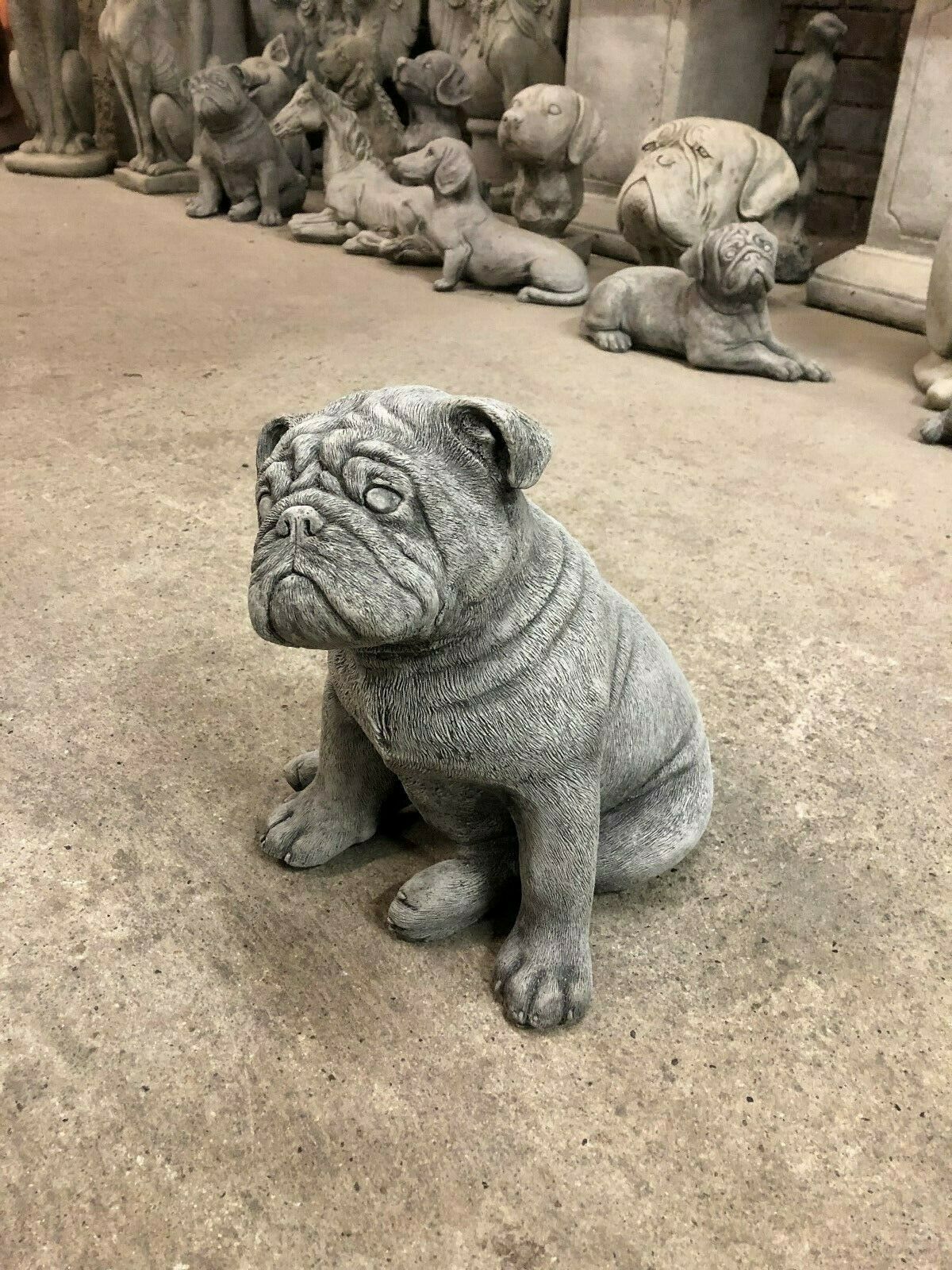 Stone British Bulldog Puppy Statue in a seated pose, showcasing realistic texture and weatherproof design for outdoor use.
