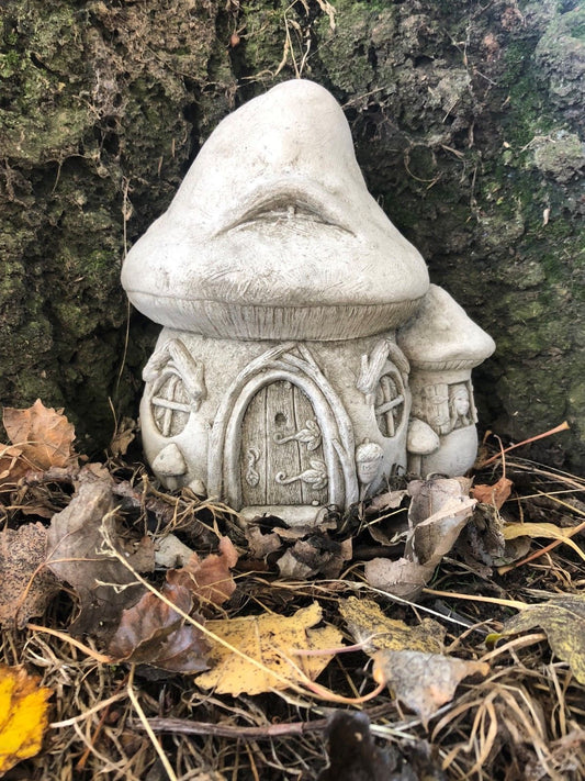 Fairy Toadstool Garden Ornament - Stone House nestled among autumn leaves, ideal for whimsical outdoor garden decor.