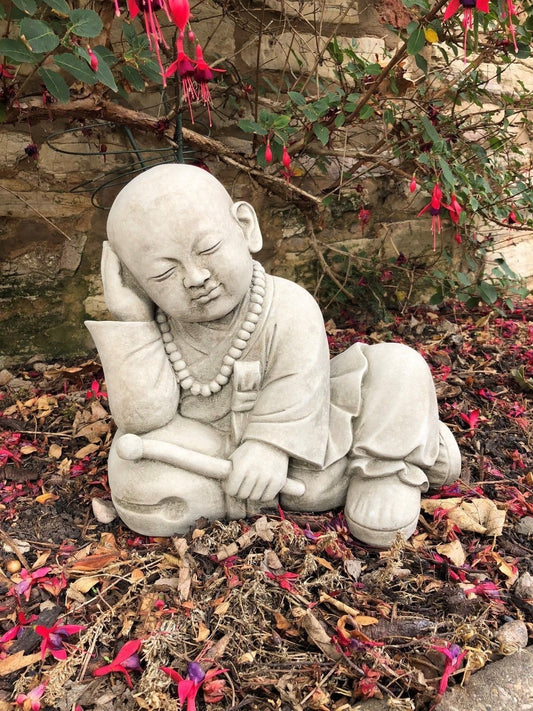 Stunning Stone Resting Monk Sculpture Garden Ornament featuring a peaceful child monk in antique grey limestone, ideal for outdoor garden décor.