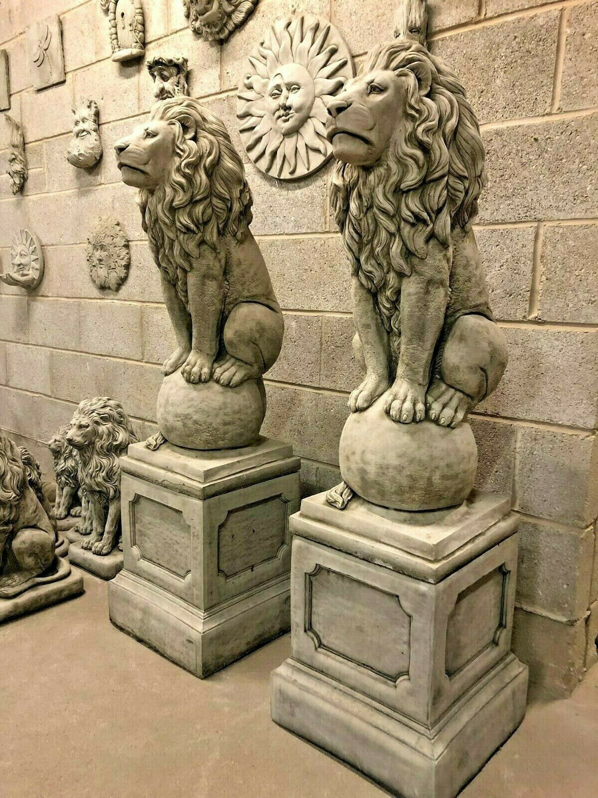 Pair of stone lion garden statues made from heavy fine limestone, seated on spheres atop square plinths, ideal for grand garden entrances.