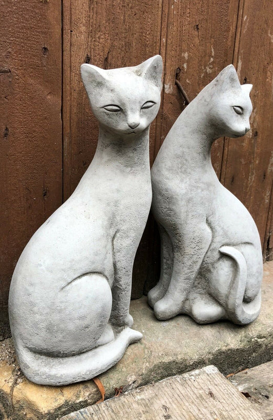 Garden Siamese Cat Statues - Stone Pair sitting side by side on a stone step, perfect for outdoor decor and weatherproof garden ornamentation.