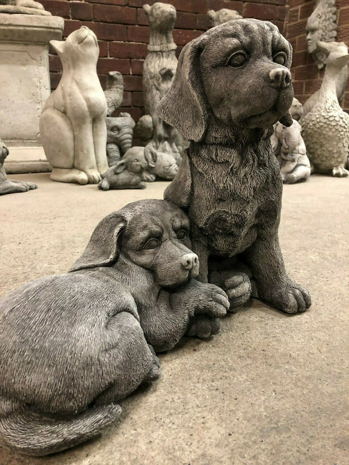 Pair of stone Labrador statues with realistic texture, perfect for enhancing patios, flowerbeds, or indoor decorative spaces.