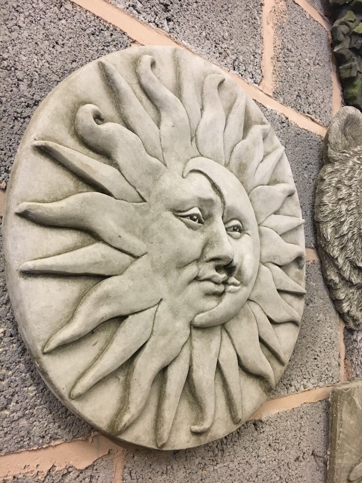 Large stone sun moon wall plaque with detailed facial features, ideal for outdoor wall decor in gardens or patios.