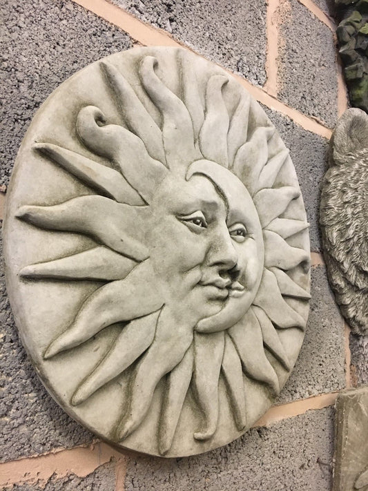 Large stone sun moon wall plaque with detailed facial features, ideal for outdoor wall decor in gardens or patios.