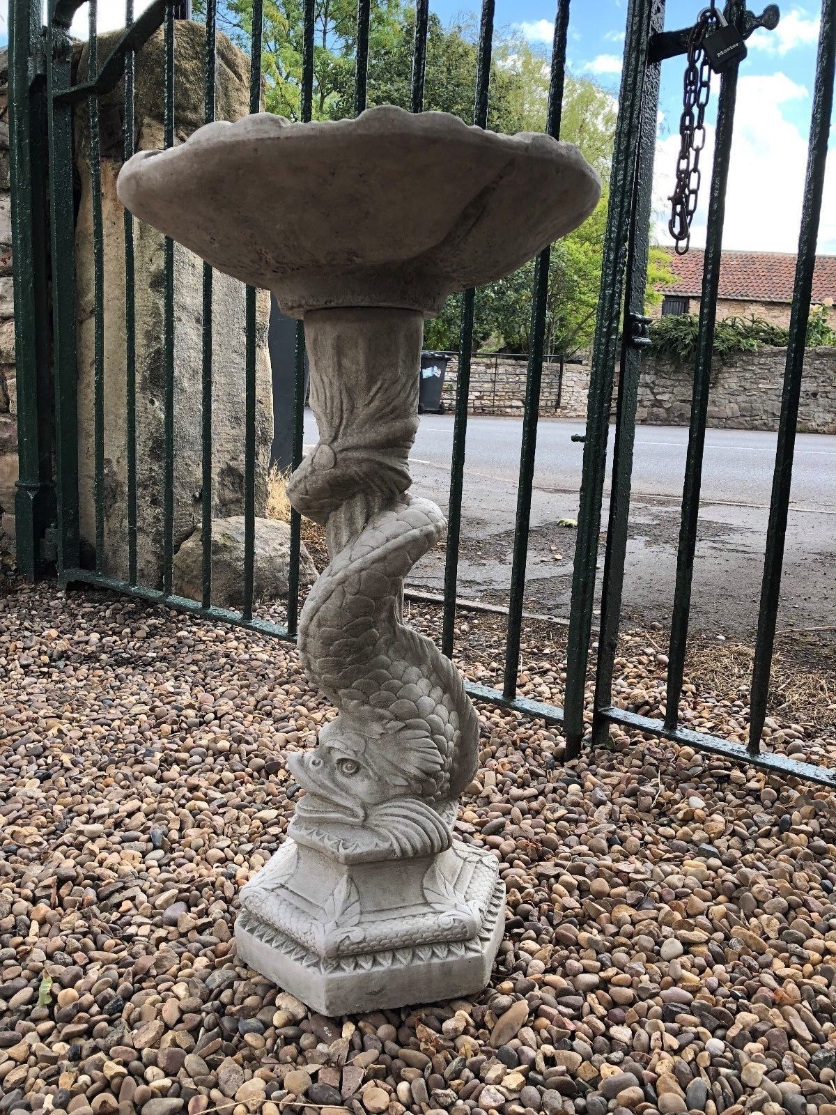 Stylish Stone Serpent Bird Bath featuring detailed serpent sculpture on pedestal, perfect for enhancing garden aesthetics and attracting birds.