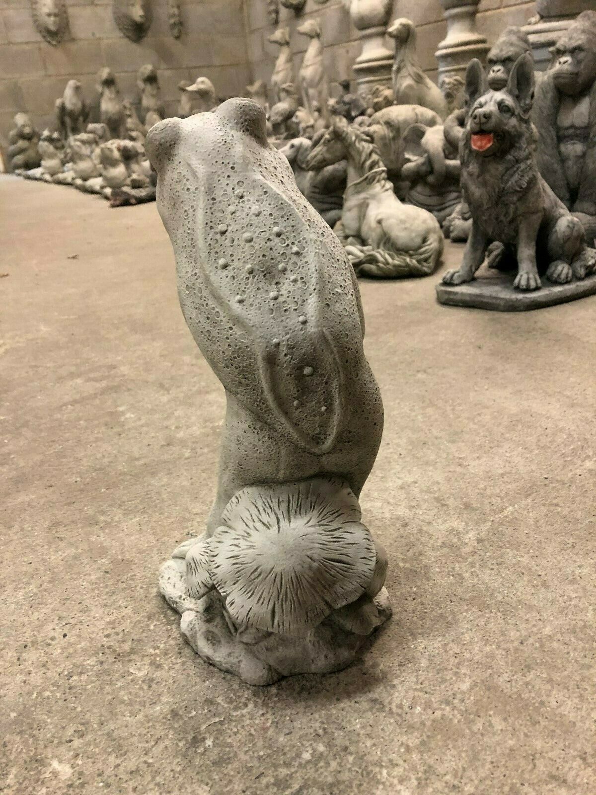 Rear view of Stone Frog Garden Ornament - Elegant with Umbrella, highlighting detailed limestone texture and mushroom base design.
