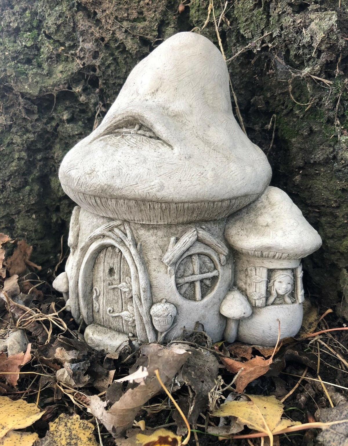 Stone Fairy Toadstool House Garden Ornament with detailed windows and mushrooms, perfect for lawn or flowerbed decoration.