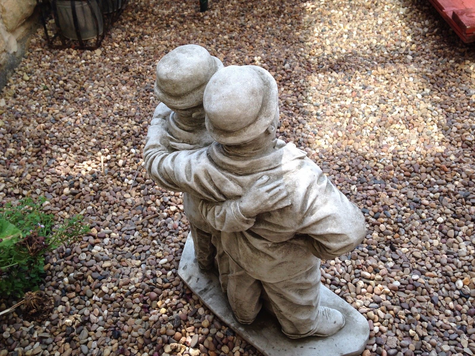 Rear view of stone Laurel & Hardy garden statue showing detailed craftsmanship and weather-resistant limestone texture.