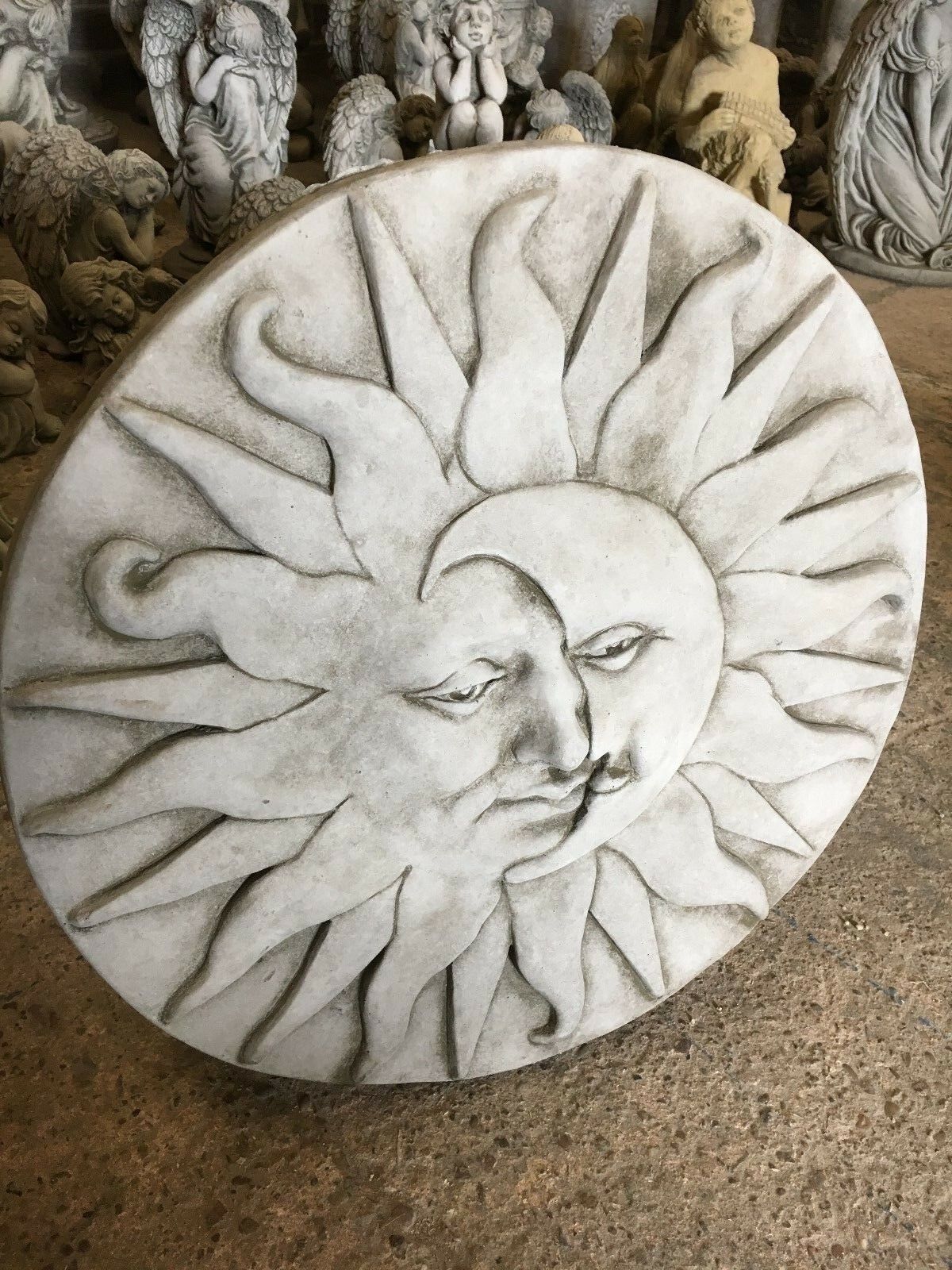 Sun moon plaque in solid stone finish, perfect as a decorative garden ornament or outdoor wall accent.
