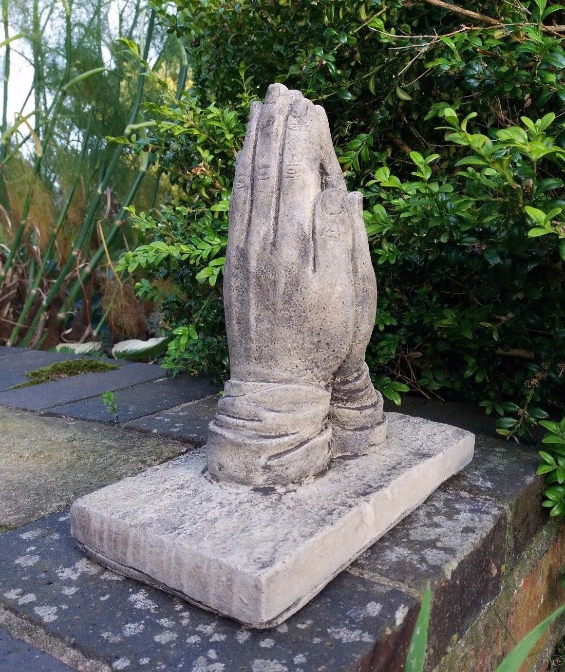 Detailed stone prayer hands ornament with realistic texture, perfect for garden memorials. Durable and weather-resistant limestone design.