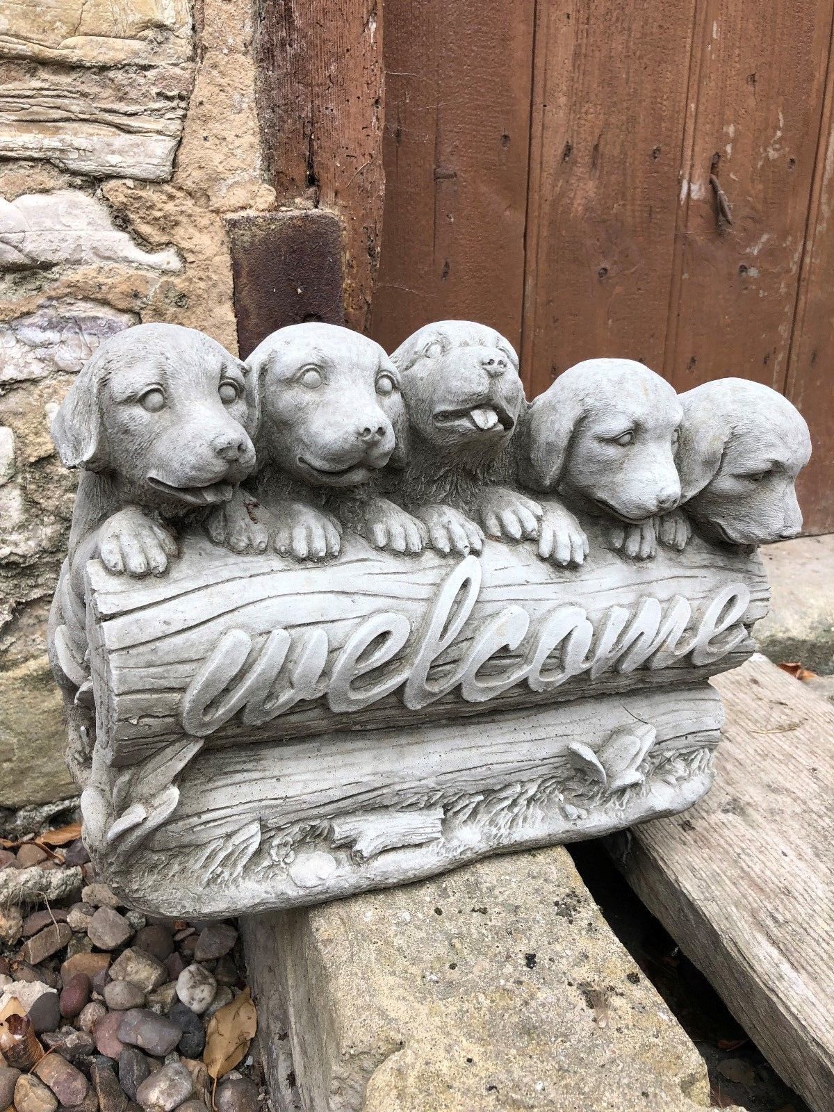 Stone Garden Welcome Puppies ornament featuring five adorable puppies on a log with 'welcome' text, ideal for outdoor garden decor.