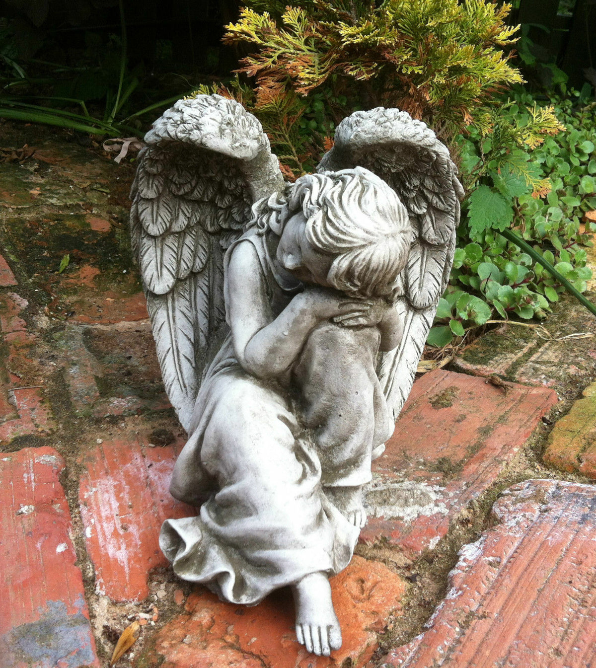 Close-up of Durable Grey Stone Winged Angel Ornament with detailed wings and robe, perfect for outdoor garden decoration.