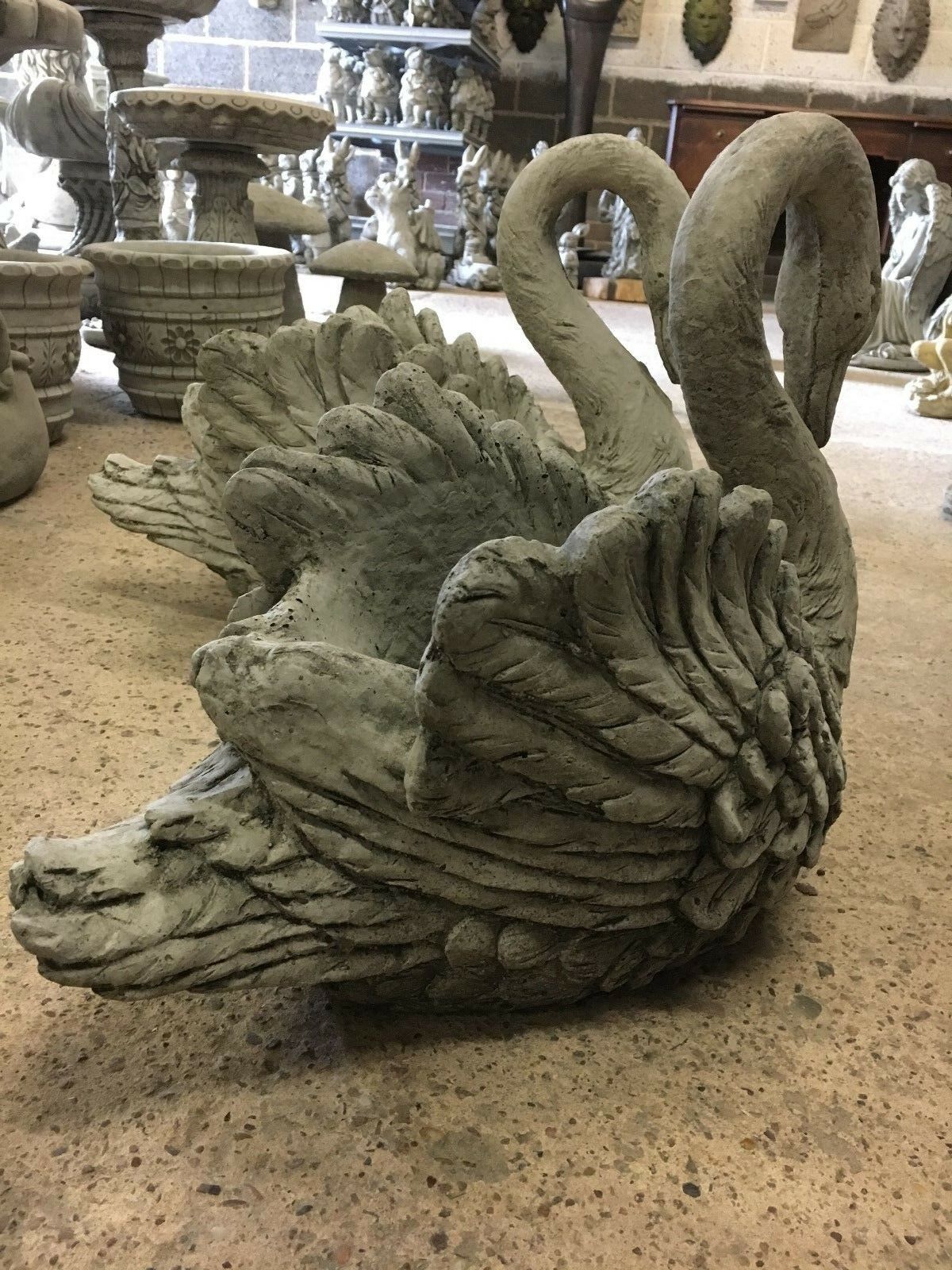 Side view of stone swan planter showing intricate wing design and deep planting cavity, perfect for flowers or small plants.