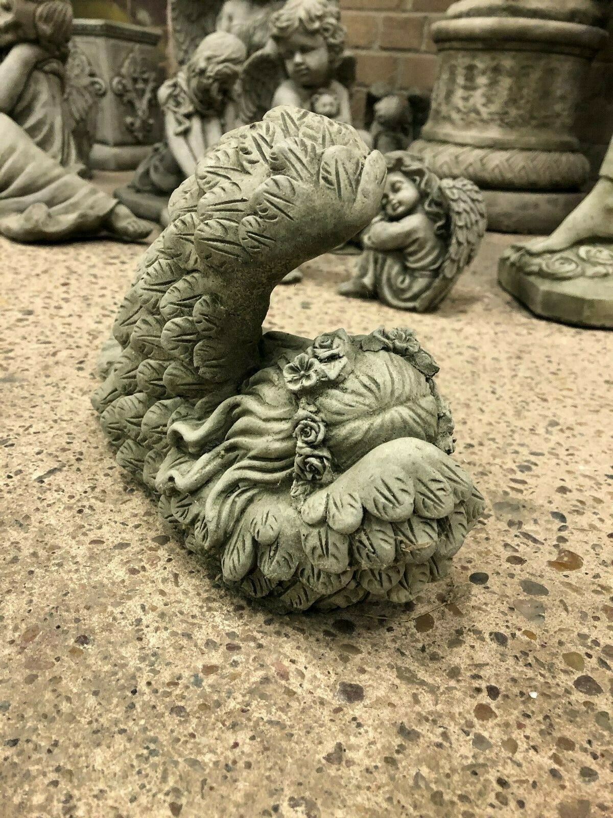 Top view of Stone Angel Tiara Ornament highlighting floral tiara and curled sleeping pose. Garden sculpture with weatherproof stone design.
