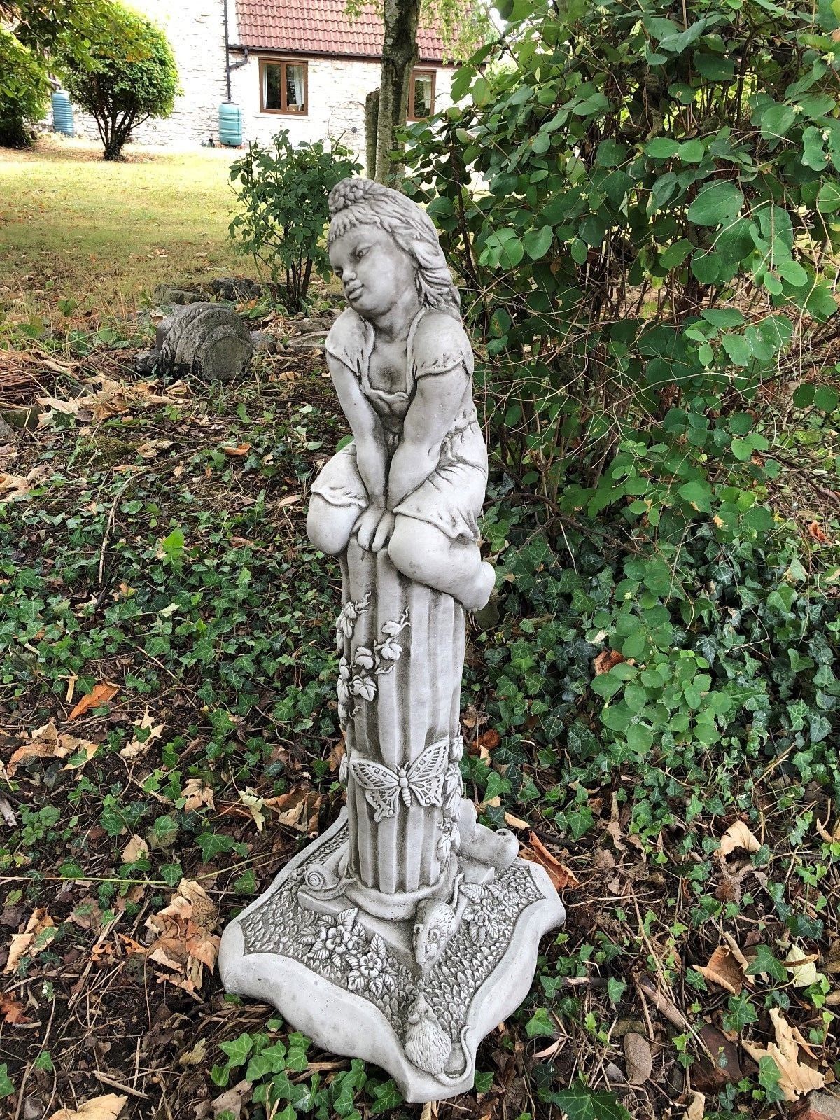 Spring-themed garden statue of a girl seated on a floral pedestal, part of the Stunning Stone Garden Statues - Four Seasons Statues collection.