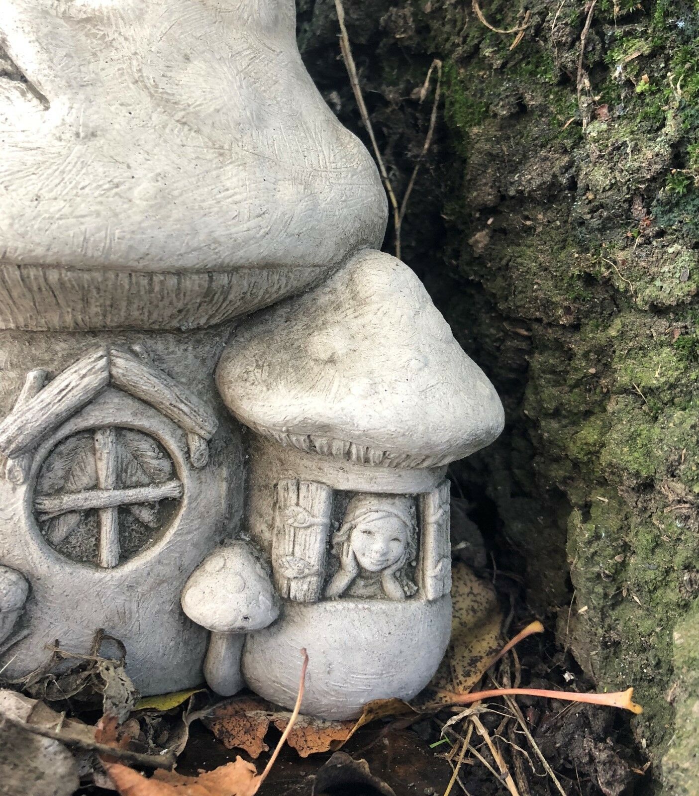 Close-up of Stone Fairy Toadstool Garden Ornament showing a fairy figure in a window, adding charm to outdoor spaces.