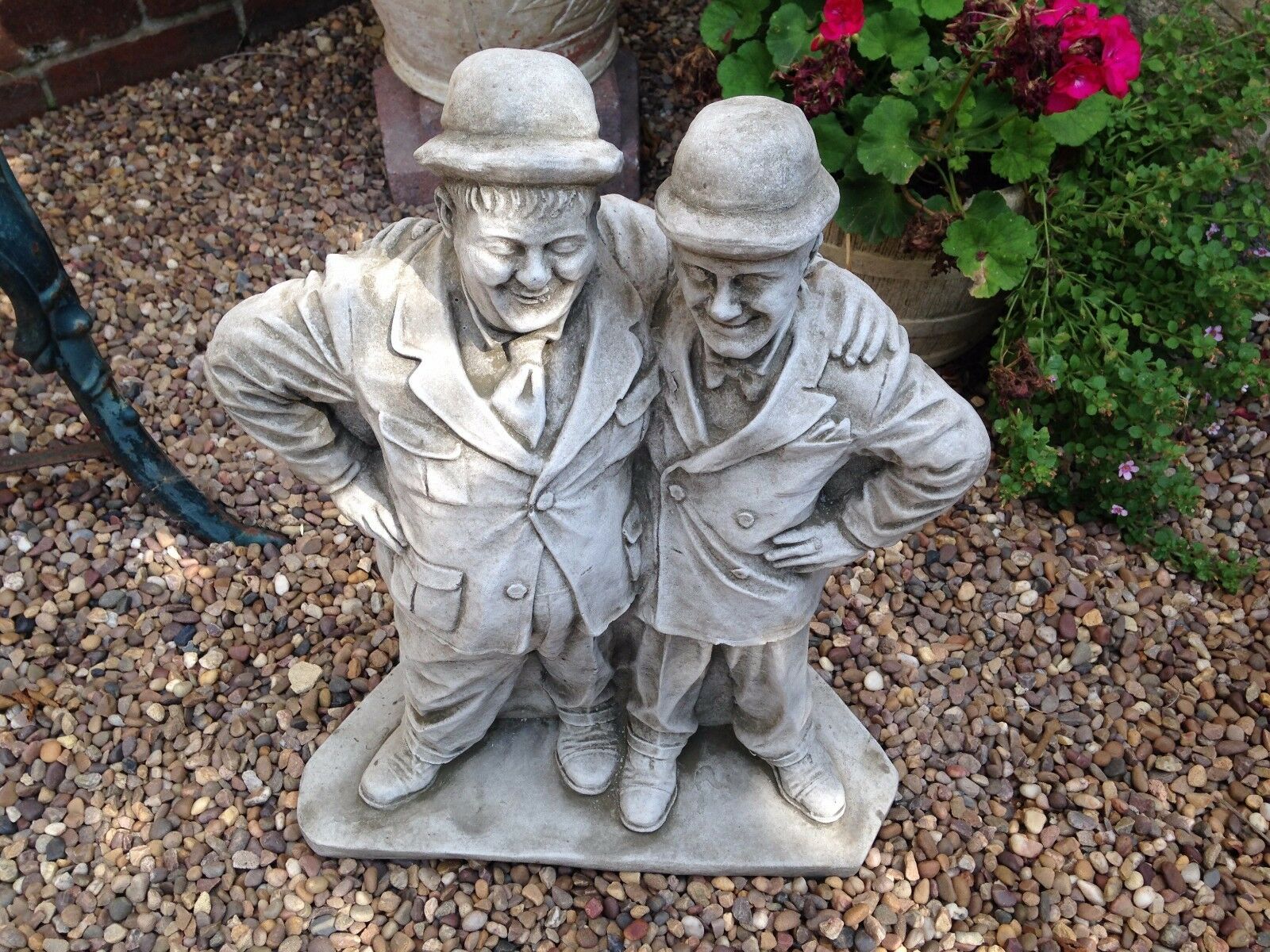 Top view of Laurel & Hardy stone garden statue with antique finish, highlighting expressive faces and classic attire.
