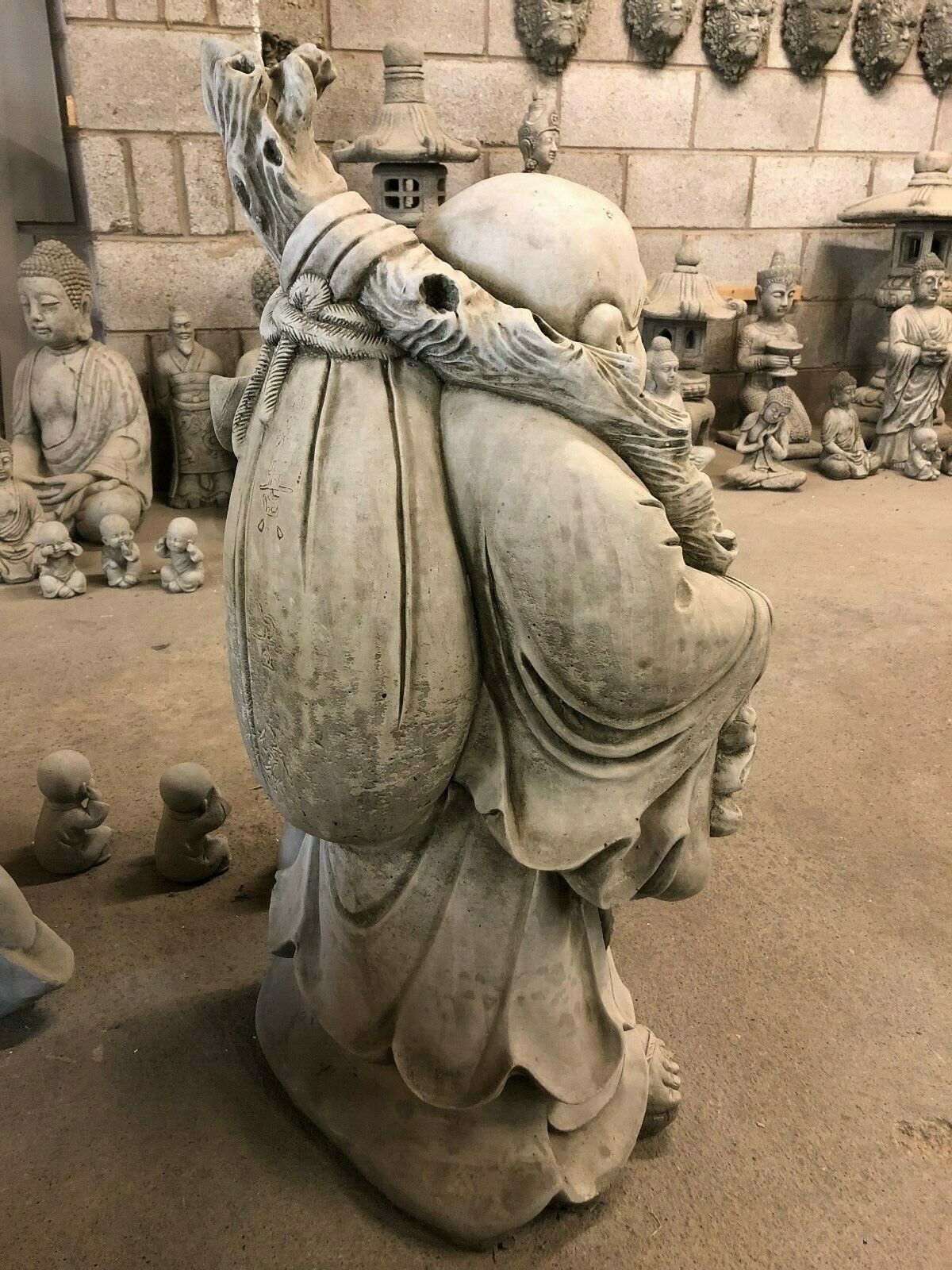Rear view of Stone Laughing Buddha Statue with large sack and robe details, ideal for tranquil garden or indoor decor.