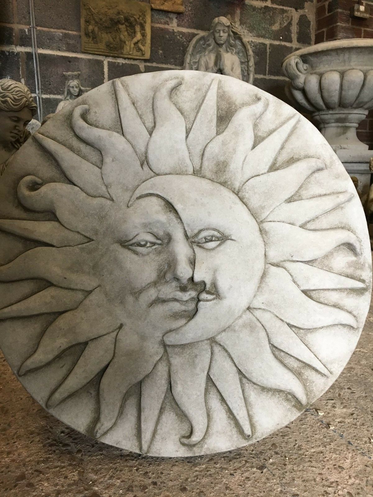 Round large stone sun moon plaque with mythological design, suitable for home and garden wall decoration.