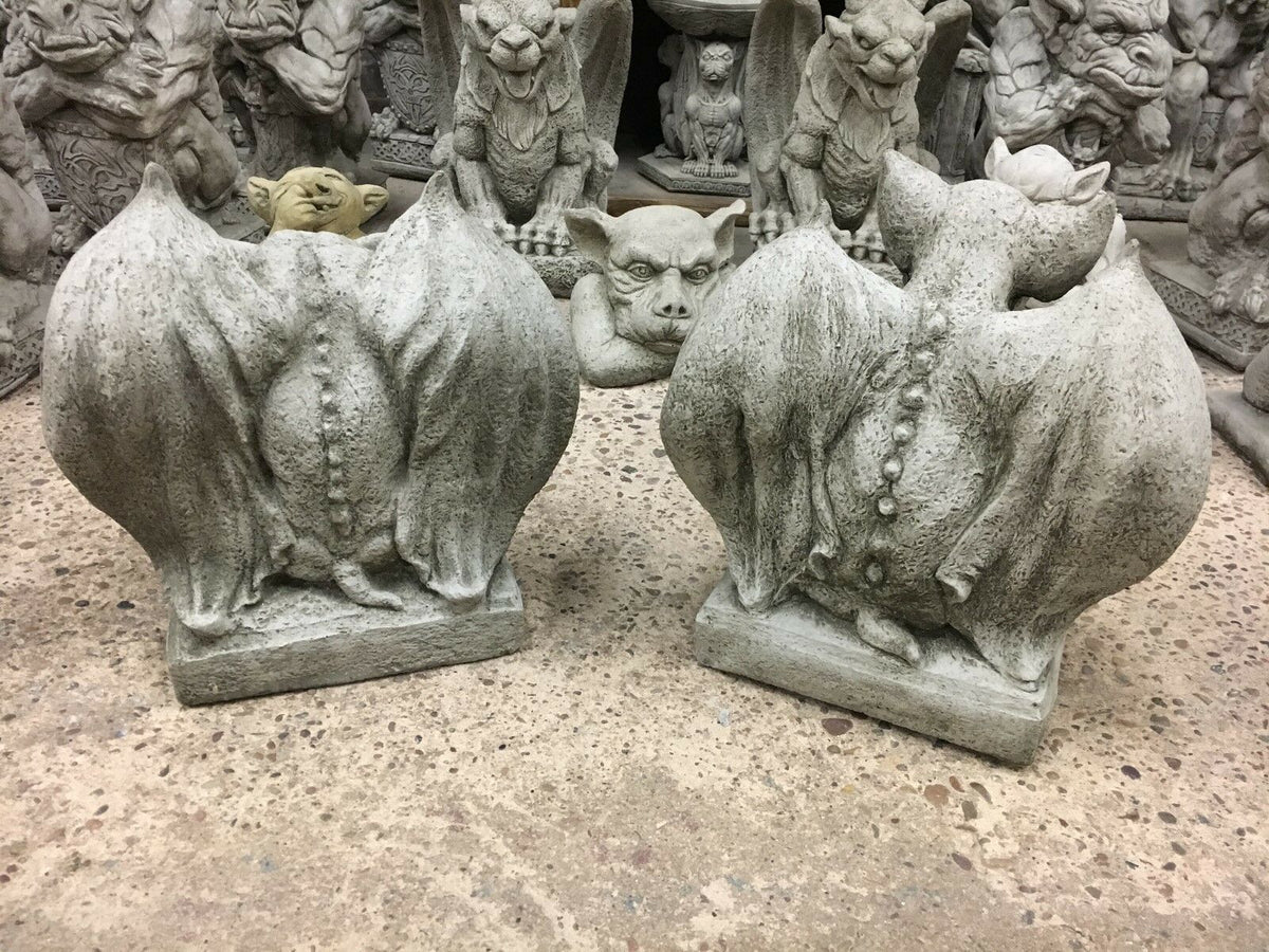 Back view of stone winged gargoyle statues showing detailed spine and wing texture, crafted for outdoor garden decor.