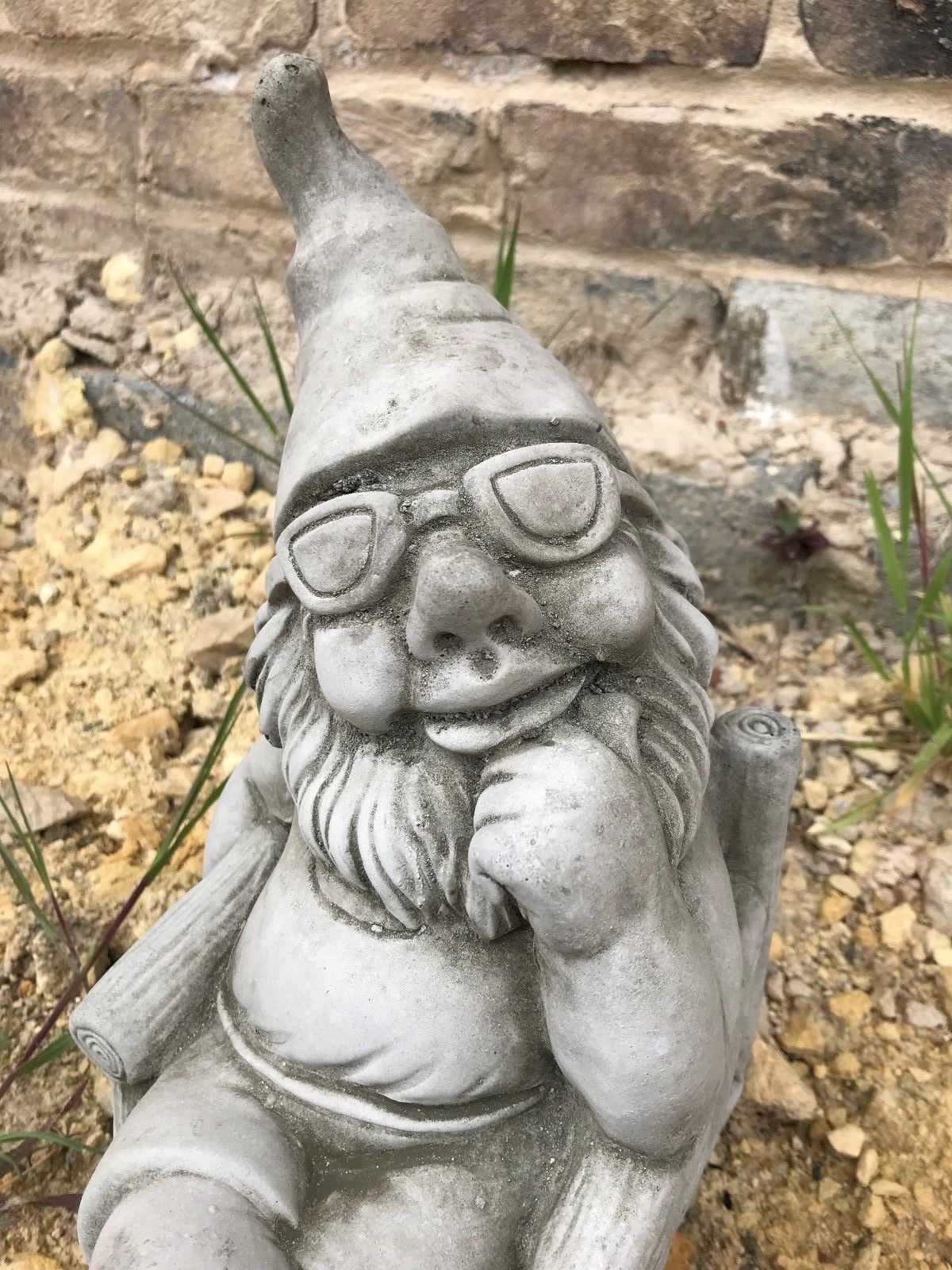 Close-up of Stone Sunbathing Gnome Garden Ornament showing detailed facial features and antique limestone finish for garden decor.