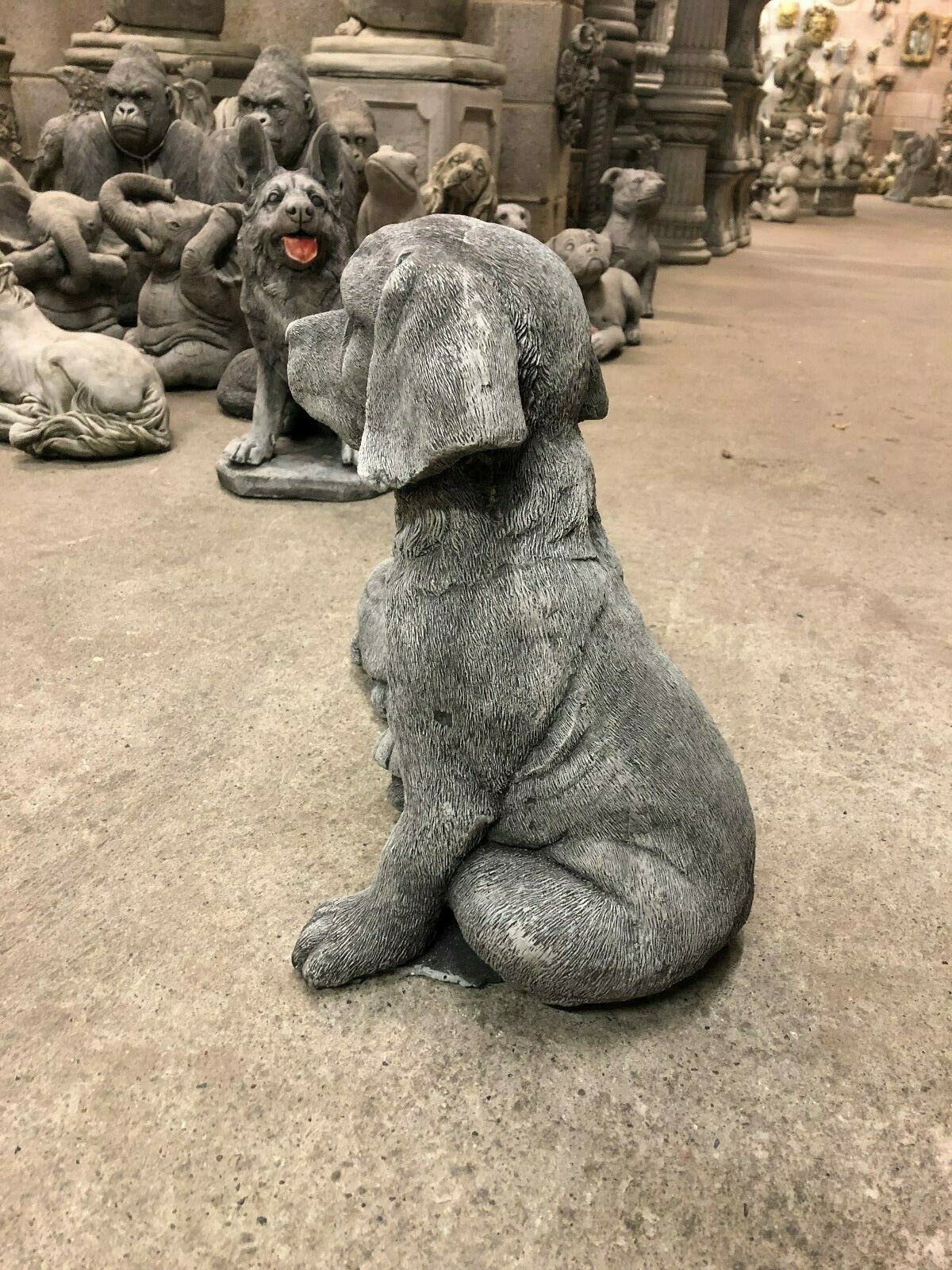 Side view of seated stone Labrador statue, showcasing fine craftsmanship and texture for home or garden ornament use.