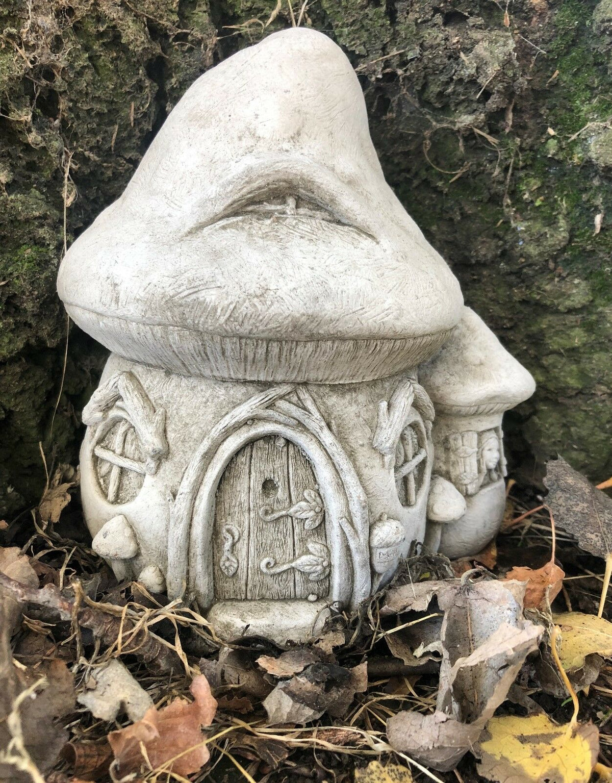 Front view of Stone Fairy Toadstool House Garden Ornament featuring intricate door and window carvings for magical garden decor.