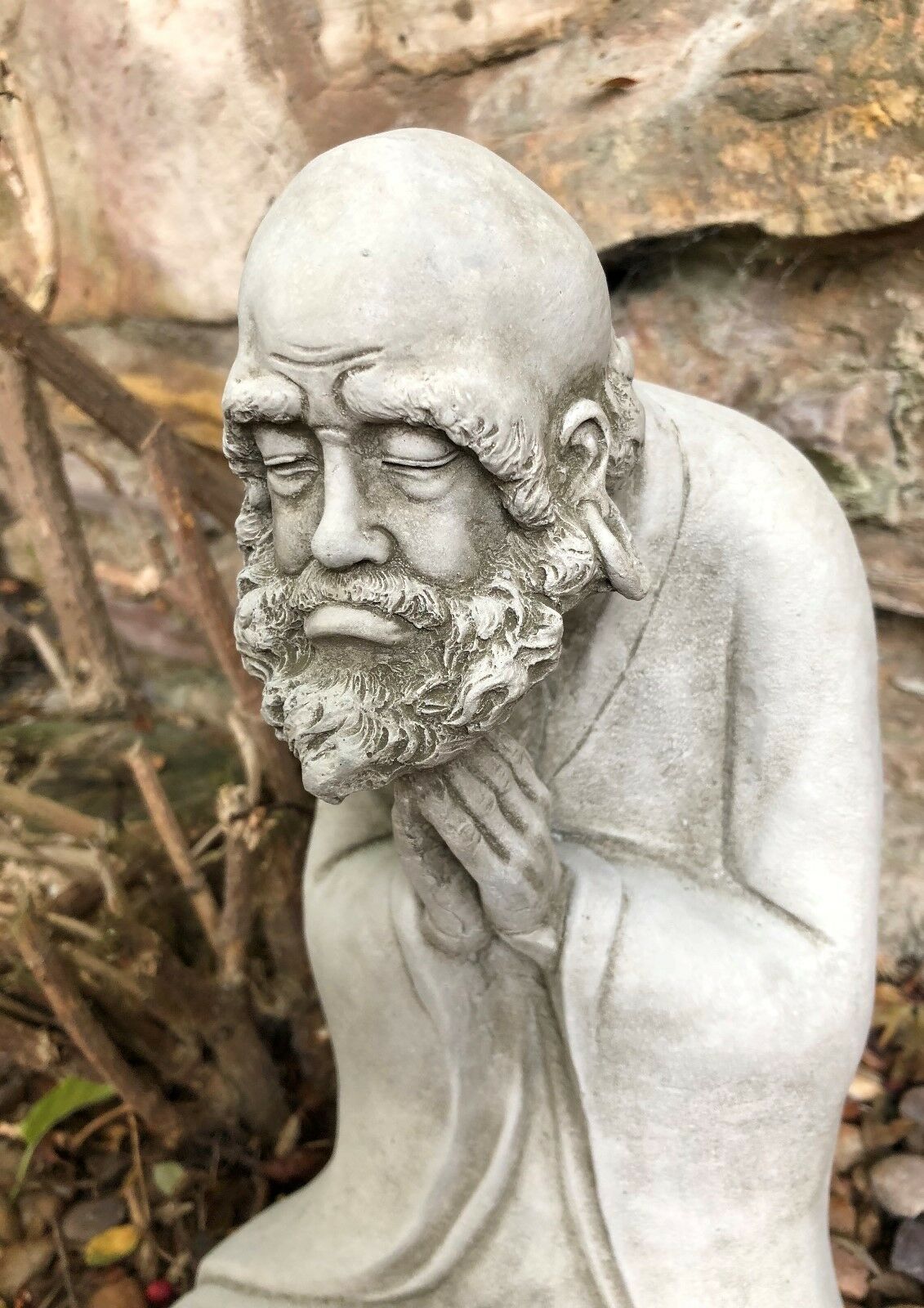 Zoomed-in view of the Stunning Stone Praying Old Monk Sculpture Garden Ornament's facial expression, capturing a moment of deep meditation.