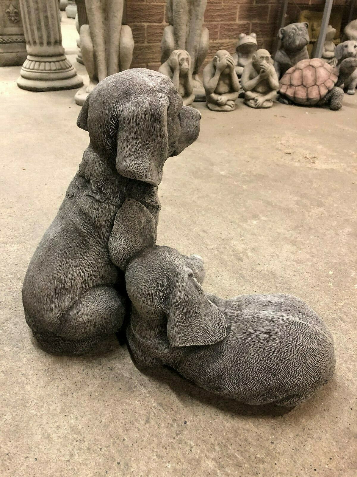 Back view of Labrador dog statue pair in stone, highlighting their cuddling pose and suitability for memorial or decorative garden settings.