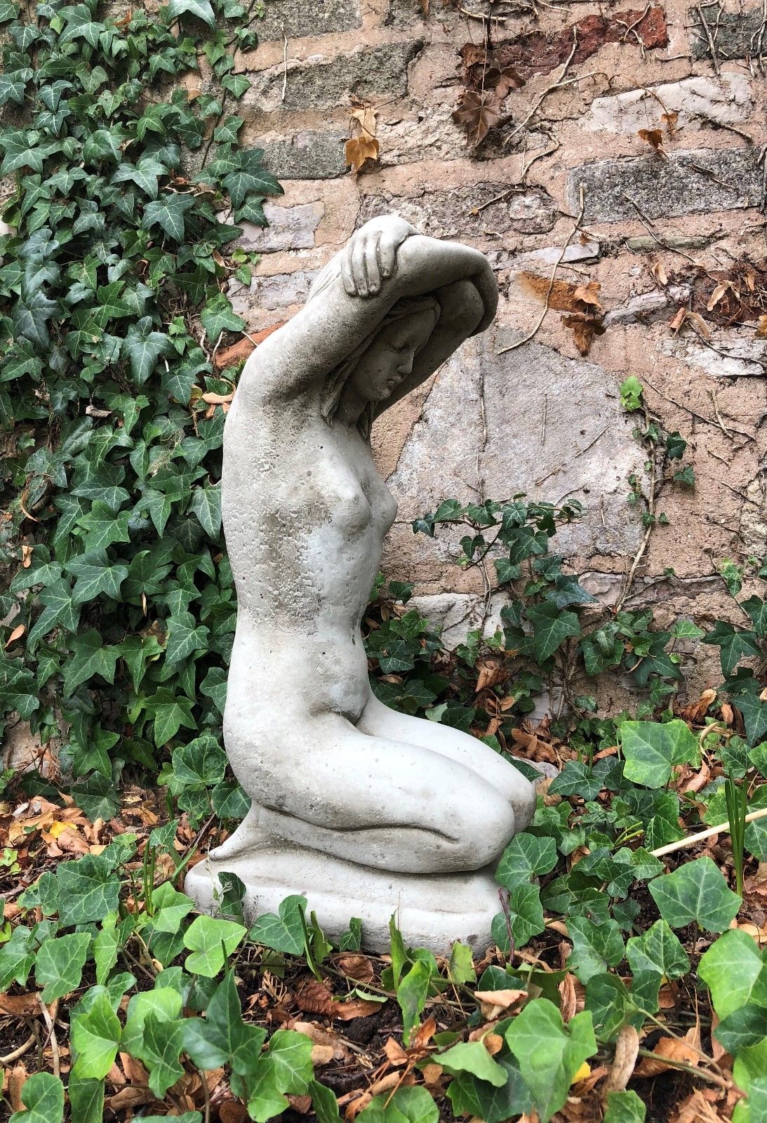 Side view of Kneeling Nude Lady Statue in stone, showing elegant contours and antique texture. Perfect for garden or balcony display.