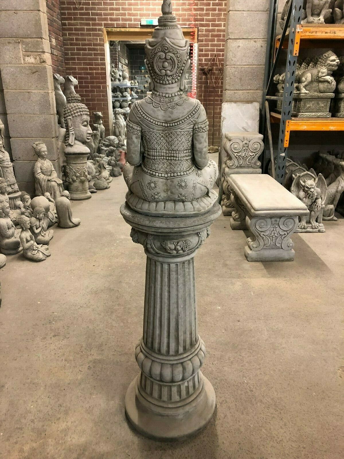 Back full-length view of Stone Seated Buddha Statue on tall pedestal, perfect for creating a zen focal point in gardens.