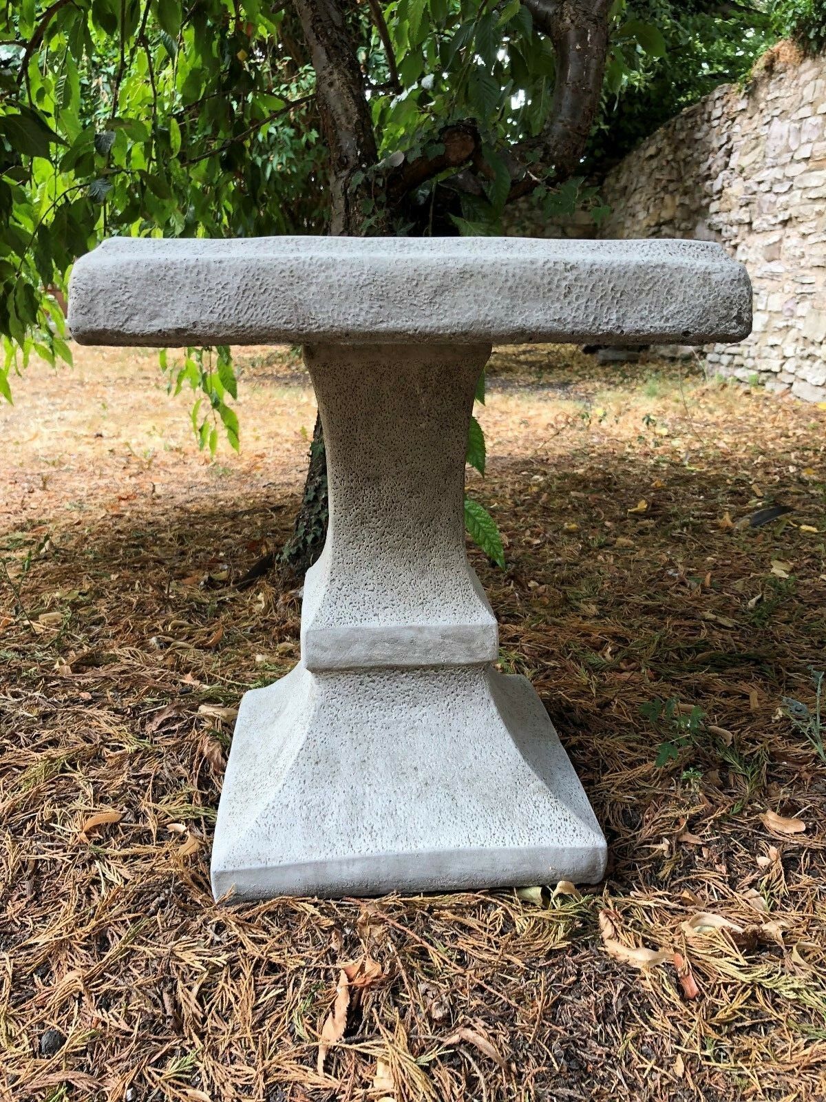 Side view of Stone Square Bird Bath - Design Sculpture showcasing its sturdy pedestal and textured stone finish for garden use.
