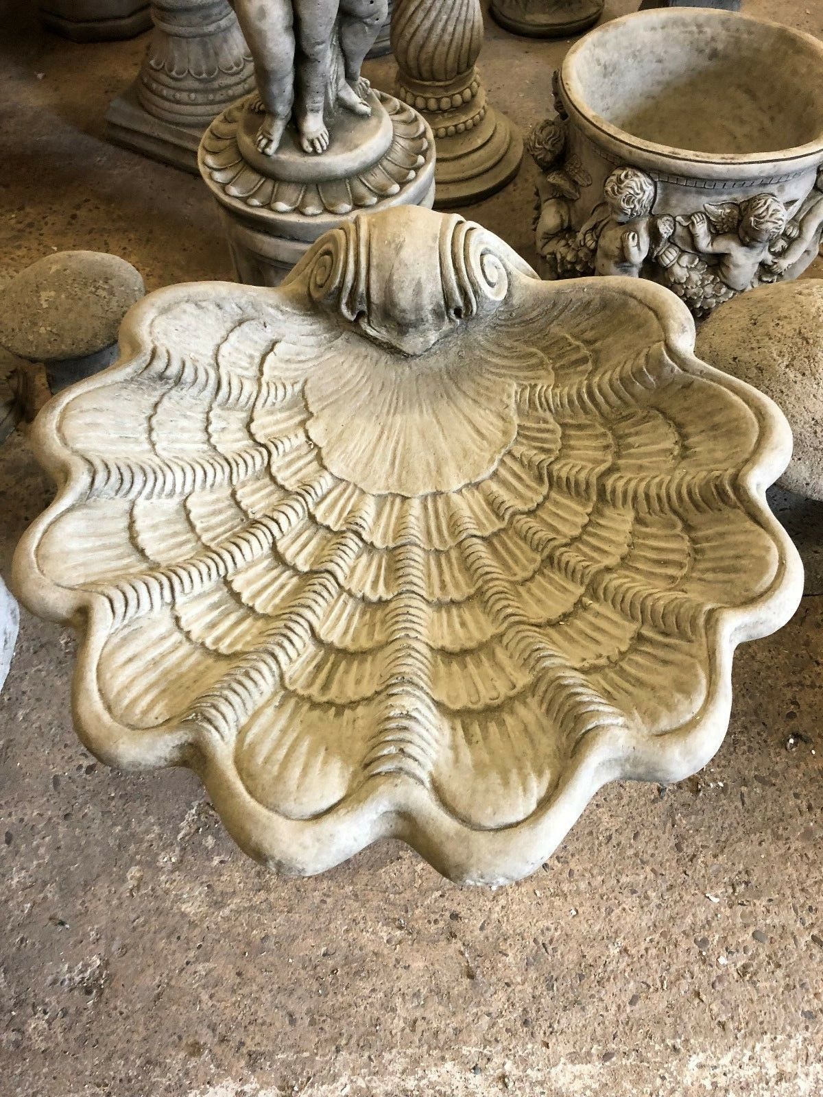 Top view of the Stone Shell Bird Bath showing intricate shell patterns and deep bowl design, ideal for outdoor bird feeding.