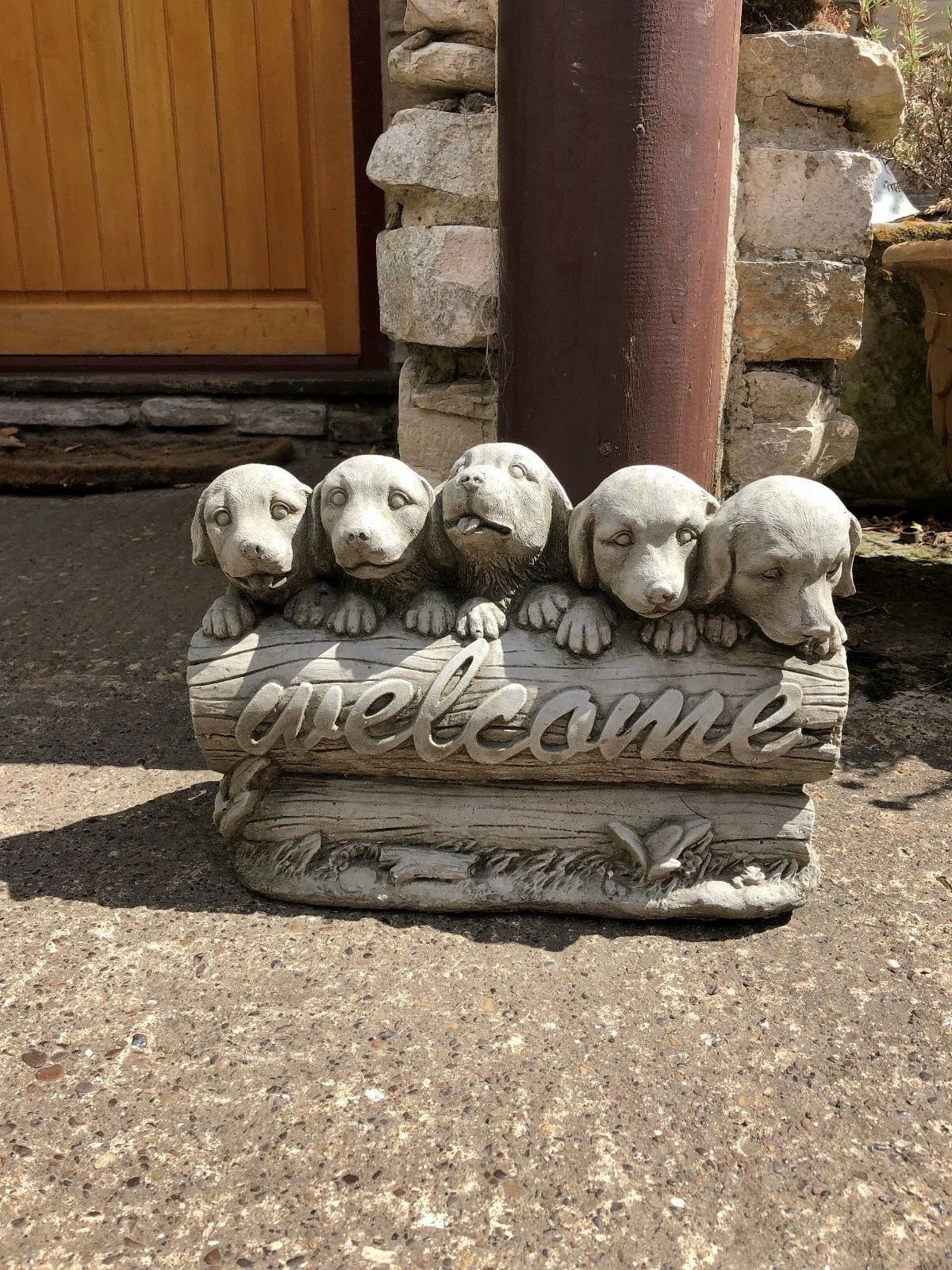 Close-up of stone garden welcome puppies sculpture, showcasing detailed craftsmanship and weather-resistant design.