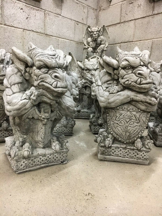 Stone sword shield gargoyle statues with fierce expressions and intricate detailing, ideal for enhancing garden décor with a medieval fantasy theme.