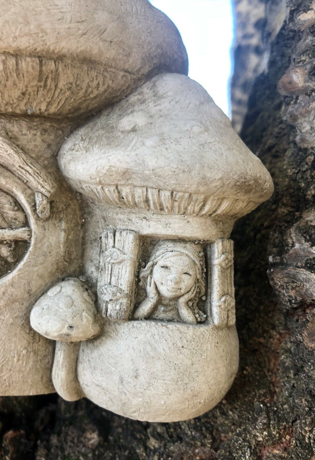 Detailed close-up of fairy figure in mushroom window of the Stone Fairy Toadstool Garden Ornament, enhancing its magical appeal.