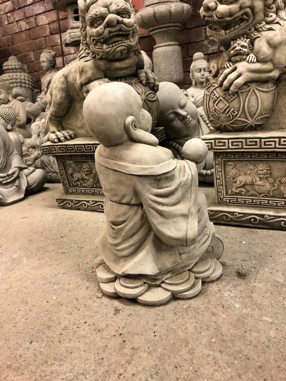Rear side of the stone Buddha statue showing robe details, designed for garden prosperity and spiritual ambiance.