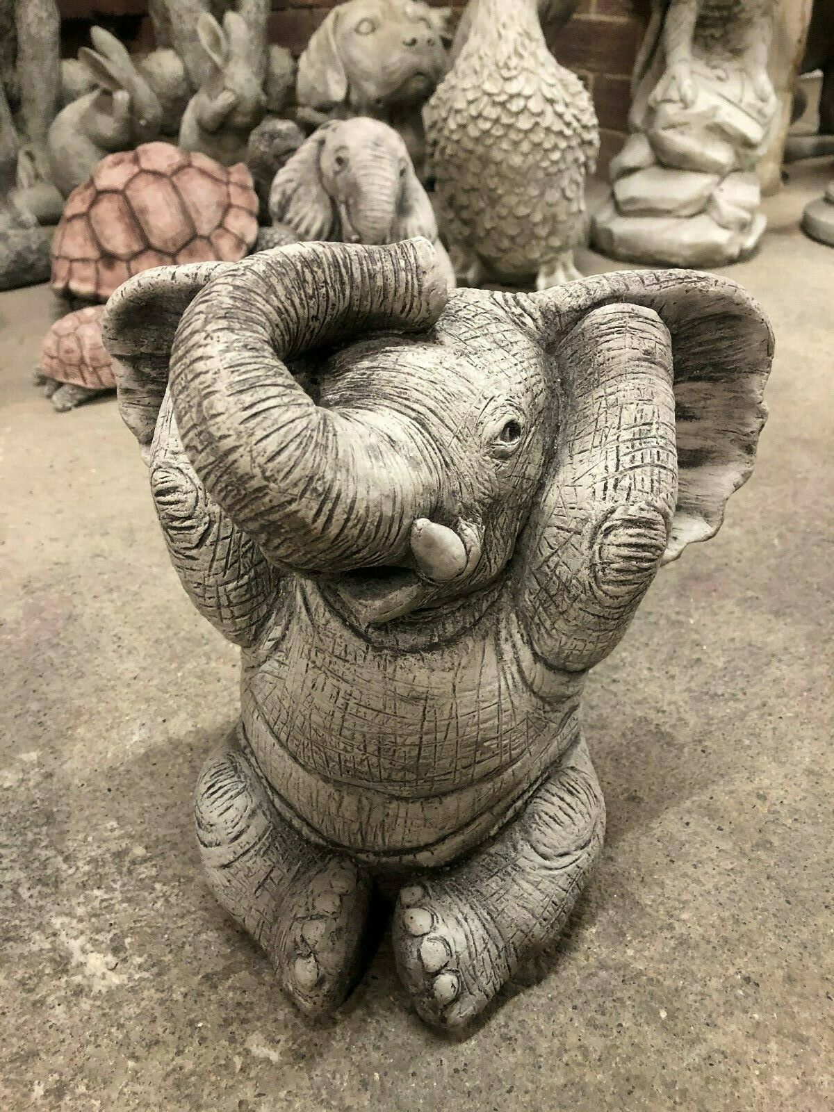 Stone elephant ornament covering ears, representing 'Hear No Evil' from the Elephant Ornaments - Hear, See & Speak No Evil stone decor collection.