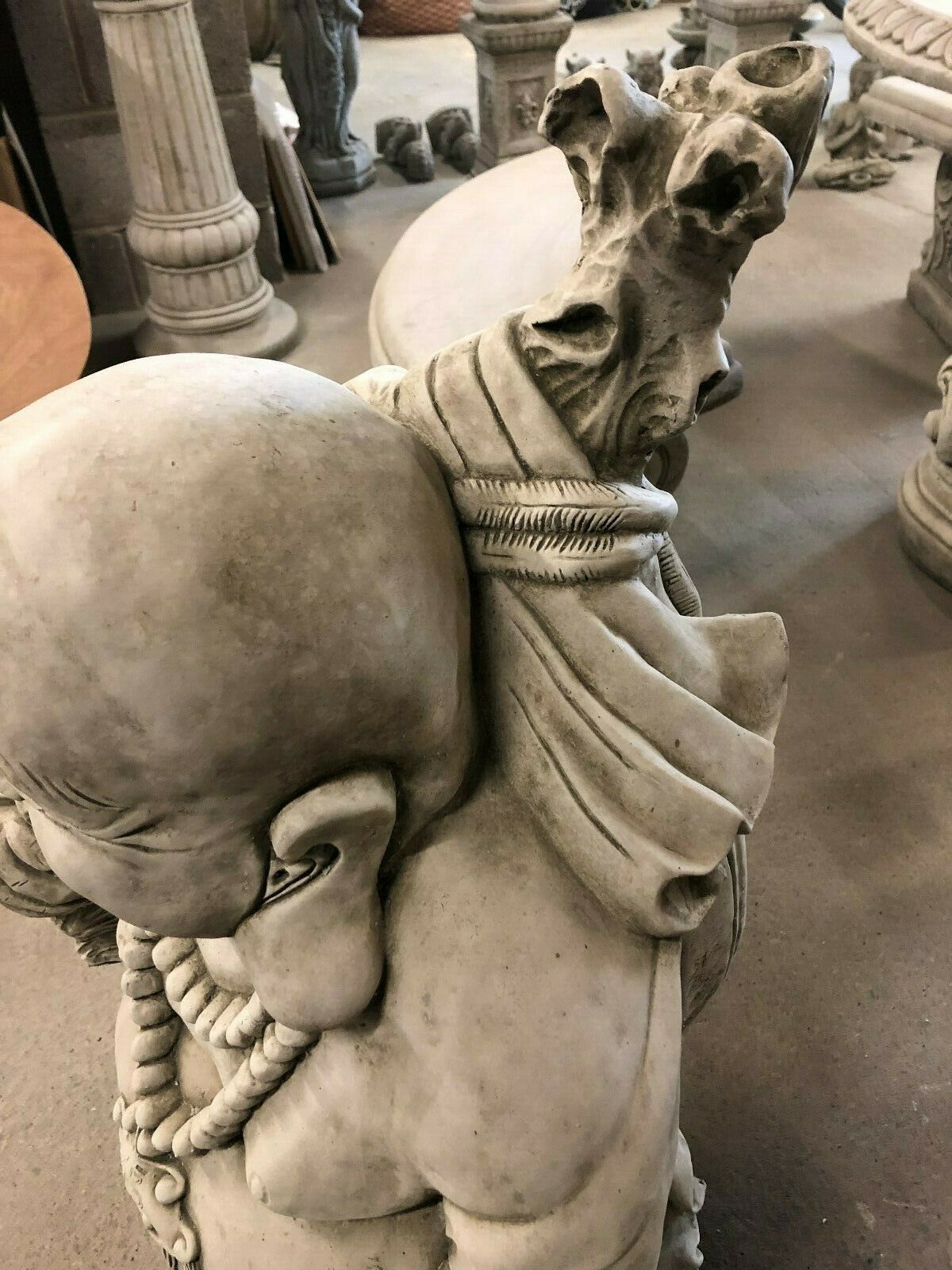 Detailed view of Laughing Buddha Statue’s sack and robe textures, showcasing artisan stone craftsmanship for fortune decor.