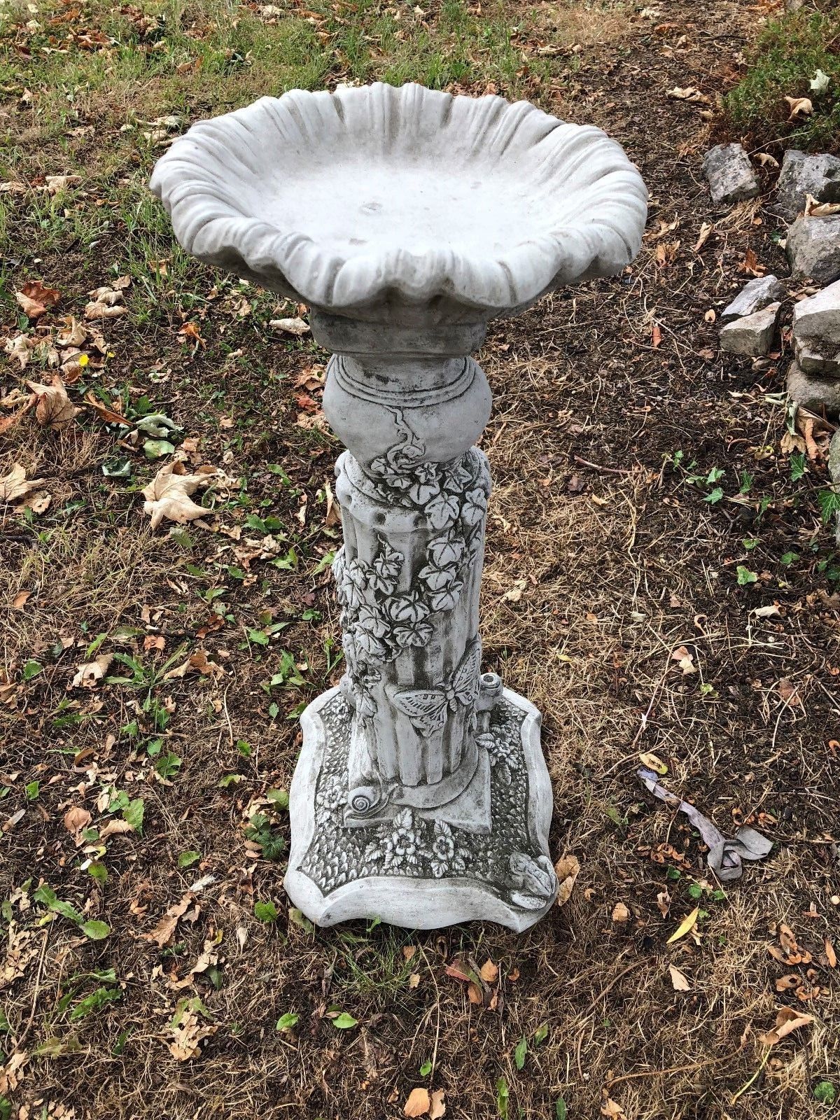 Stone bird bath from the Four Seasons Garden Statues collection, featuring ornate pedestal with ivy and seasonal motifs.