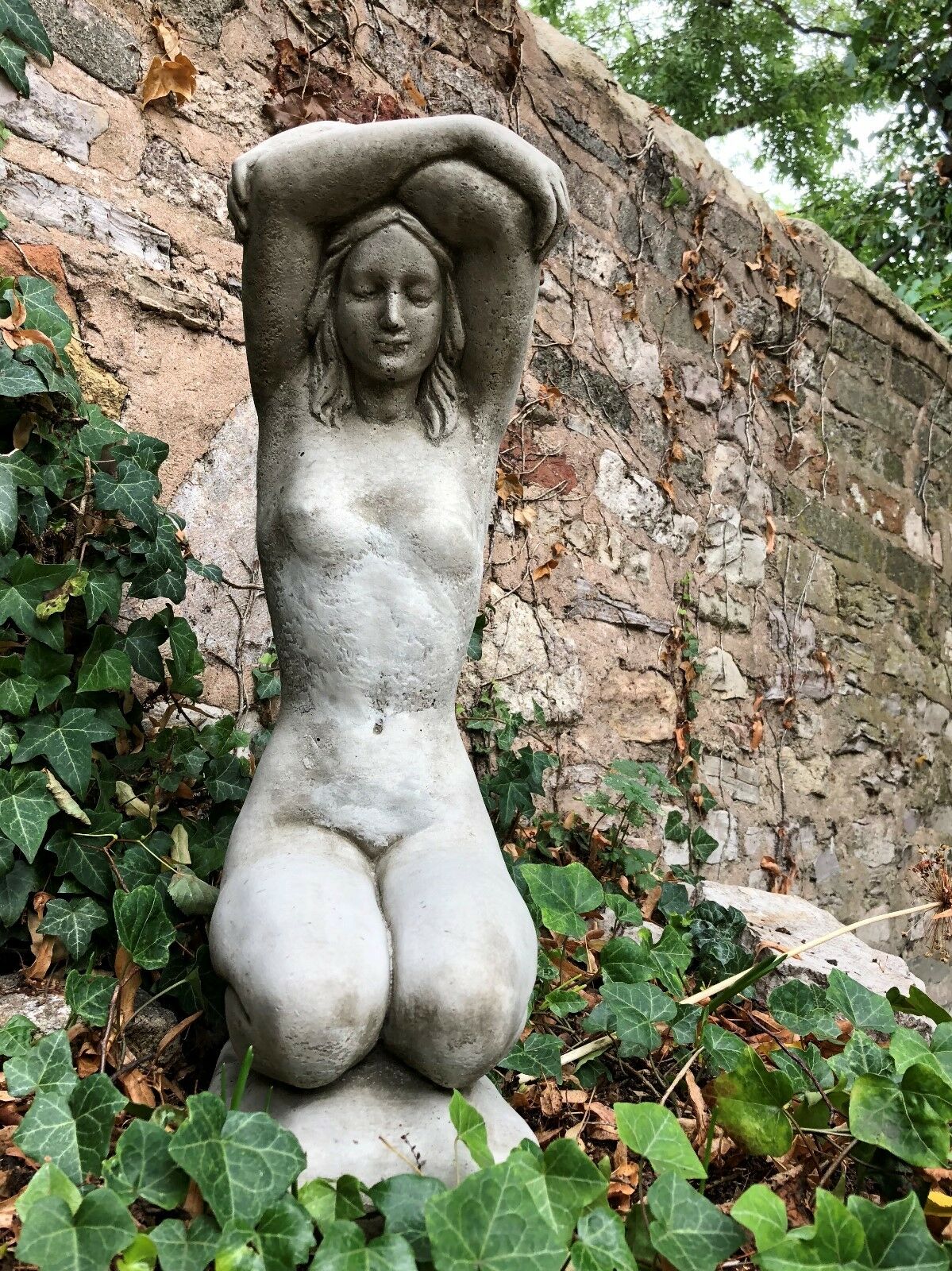 Front-facing view of limestone Kneeling Nude Lady Statue with serene expression. Elegant garden sculpture for classic outdoor decor.