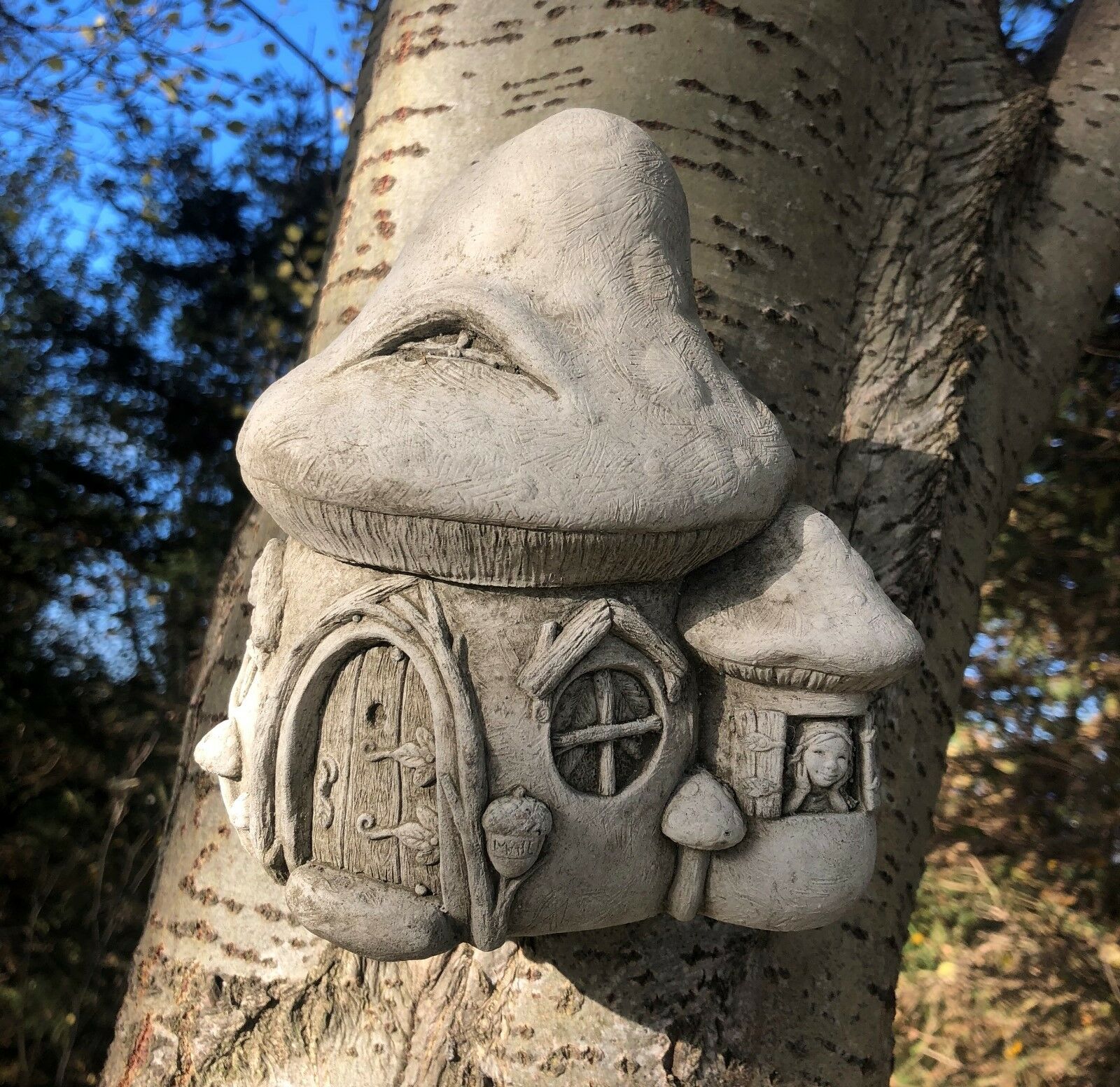 Stone Fairy Toadstool Garden Ornament mounted on a tree, showcasing its durable limestone build and fairy-tale charm.