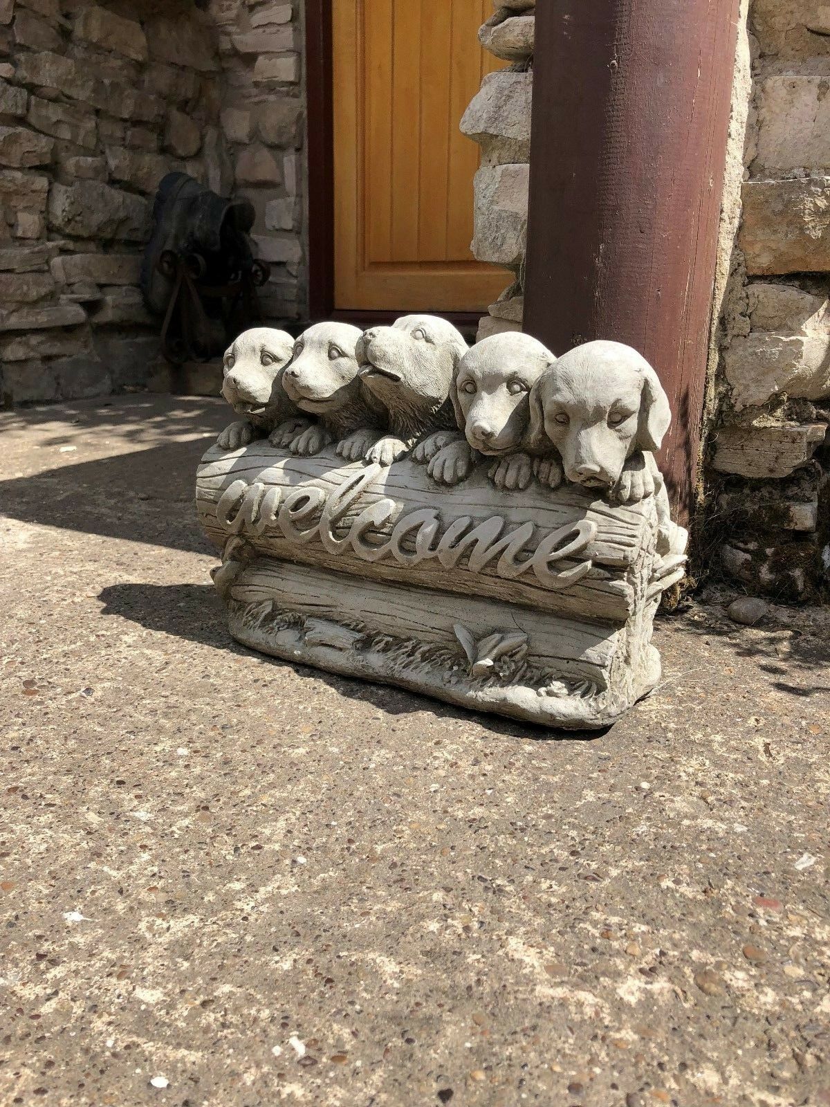 Angled shot of stone garden welcome puppies statue, ideal for lawns, patios, or decorative garden corners.
