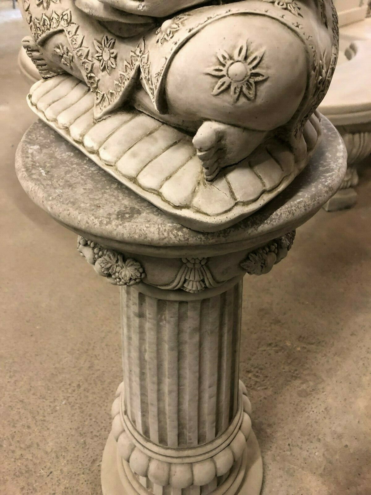 Detail of the base platform beneath the Stone Seated Buddha Statue, with floral carvings and textured stone finish.